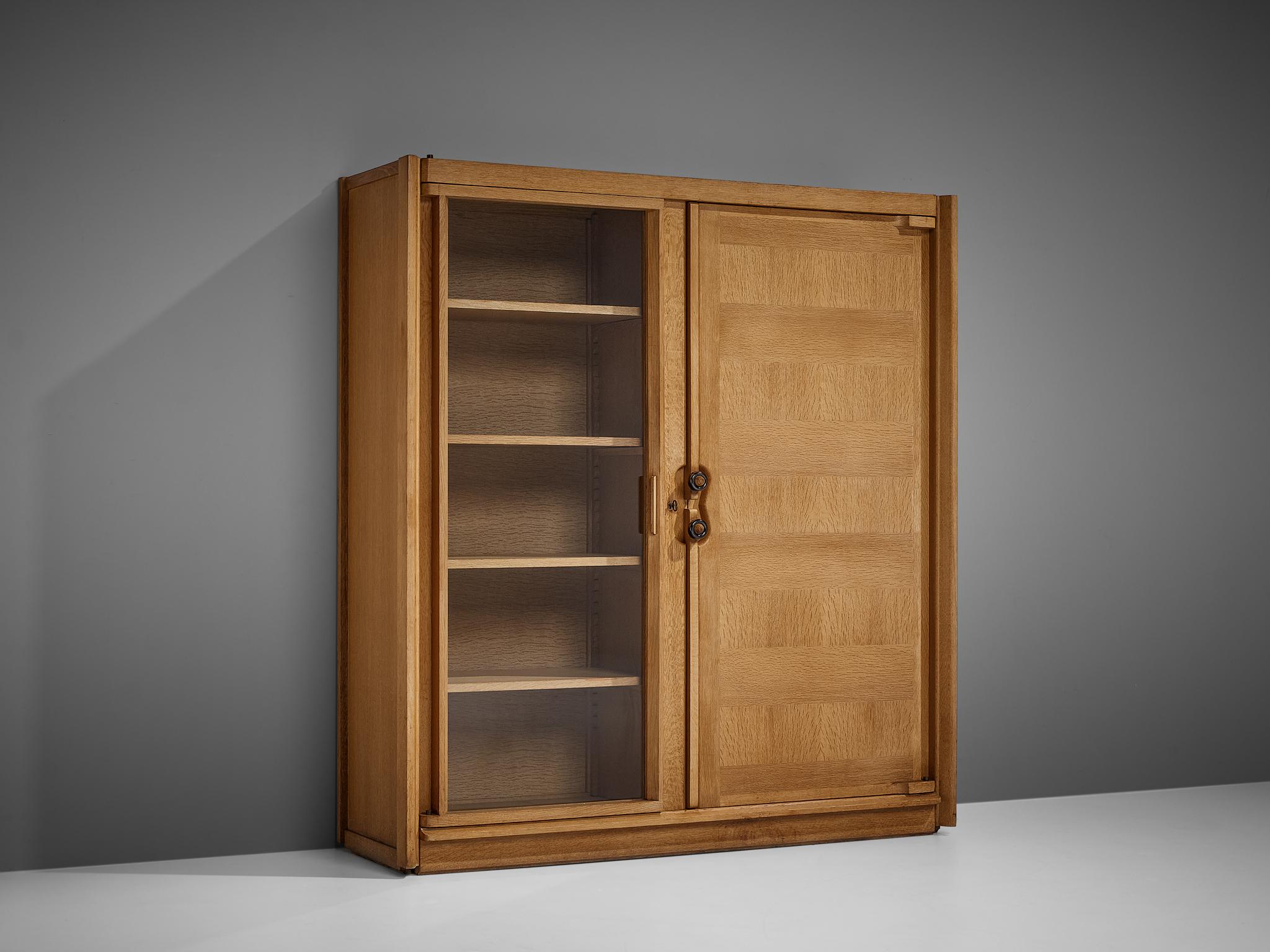 Guillerme et Chambron, cabinet, oak, glass, ceramic, France, 1960s

This case piece is designed by Guillerme and Chambron and features geometric oak inlays, creating horizontal panels on the front of the cabinet, which is characteristic for the