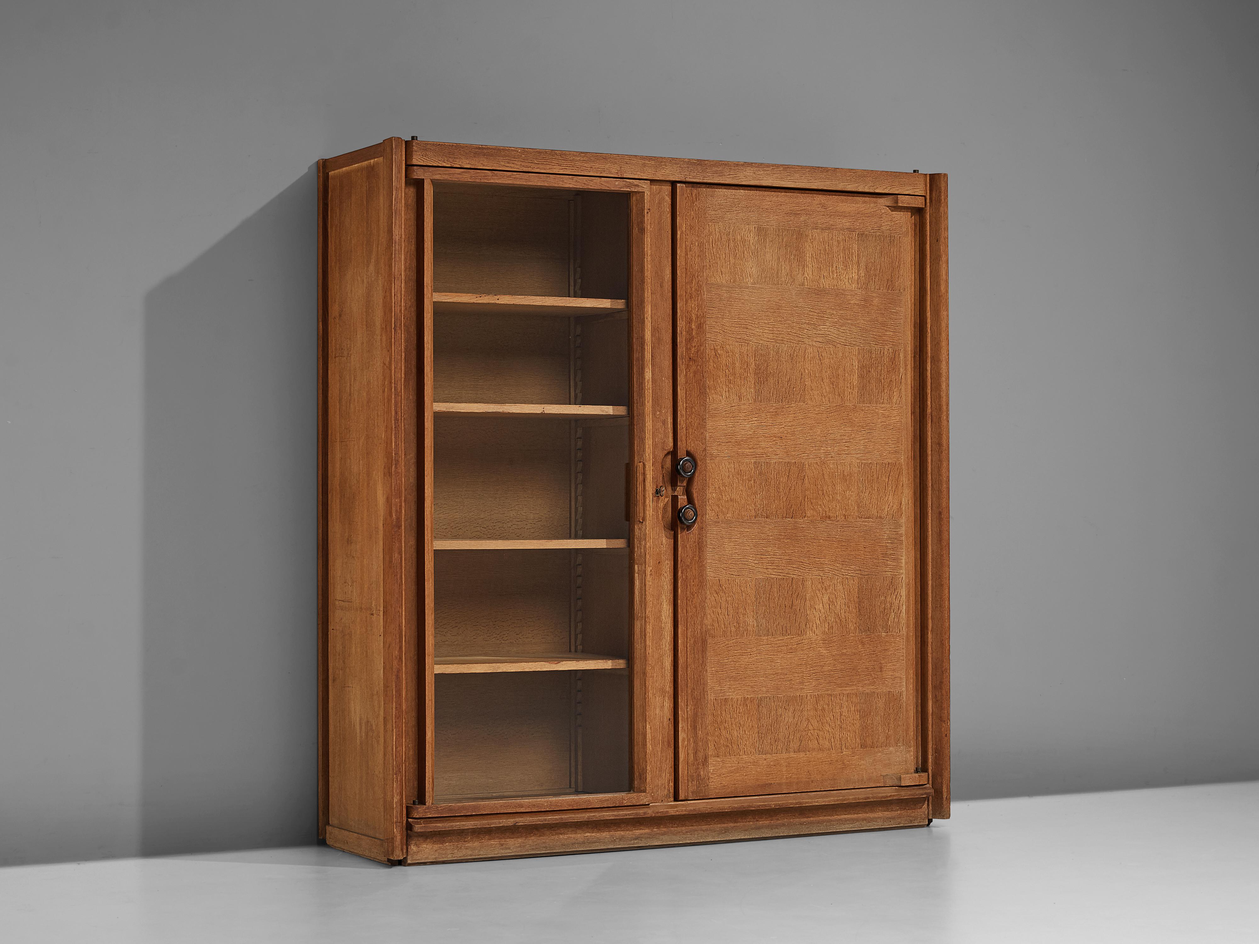 Guillerme et Chambron, cabinet, oak, glass, ceramic, France, 1960s

This case piece is designed by Guillerme and Chambron and features geometric oak inlays which create horizontal panels on the front of the cabinet. This structural motif is