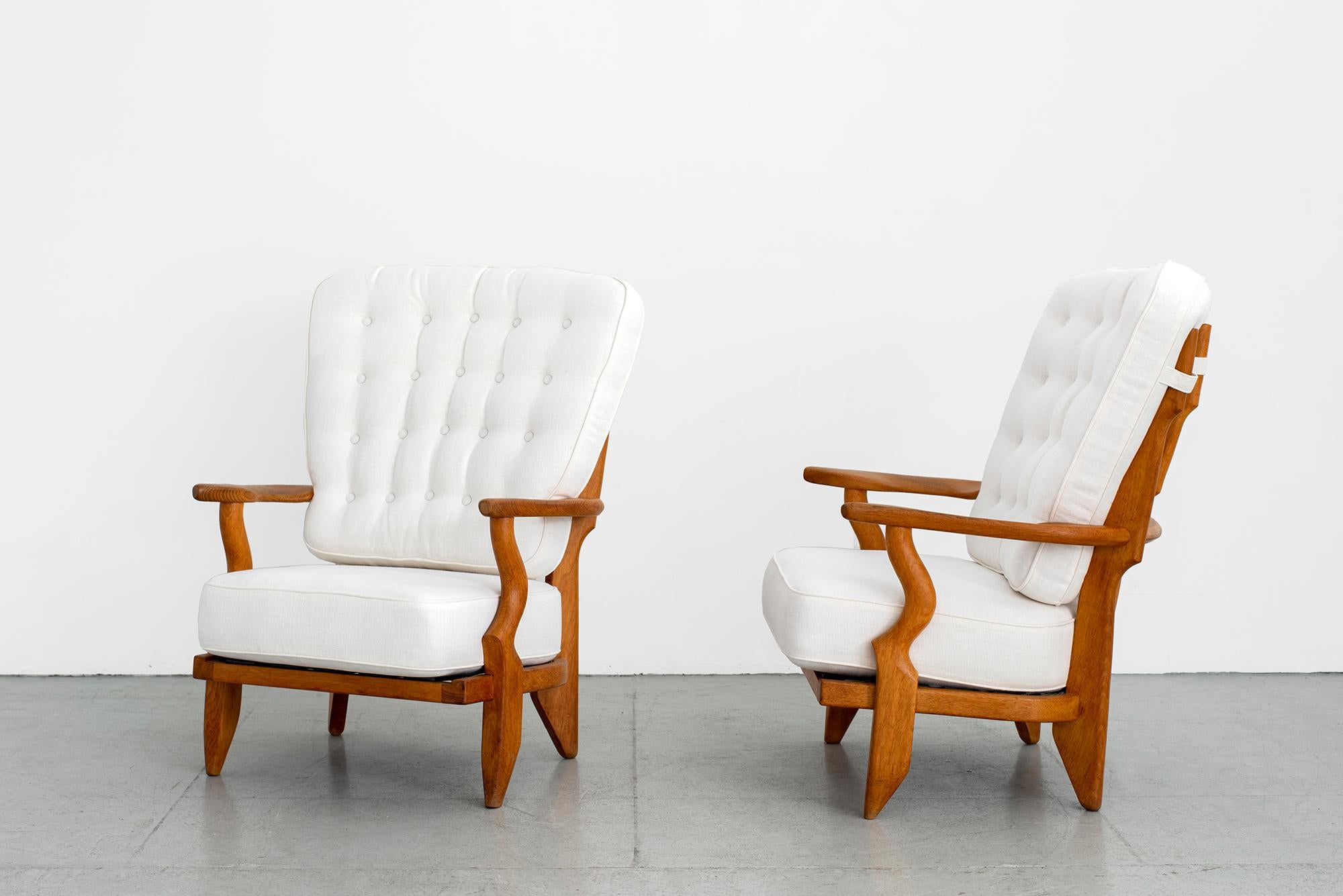 Incredible pair of armchairs chairs by Guillerme et Chambron.
Oak chairs with signature spindle back and great angled legged profile.
Newly upholstered in crisp white linen.
