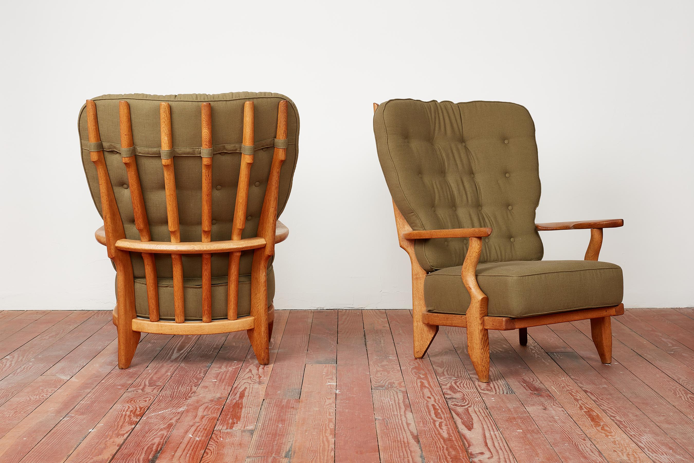 Guillerme & Chambron pair of chairs in oak with floating arms and spindle backs.
