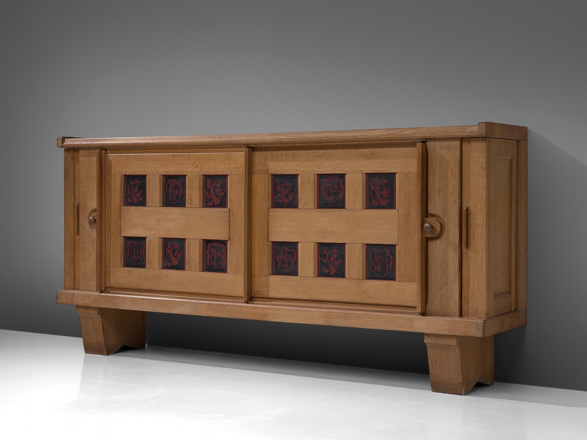 Guillerme et Chambron for Votre Maison, credenza in oak and ceramic, France, 1960s.

This well proportioned sideboard is designed by French designer duo Guillerme and Chambron. The piece is characterized by the solid oakwood and ceramic