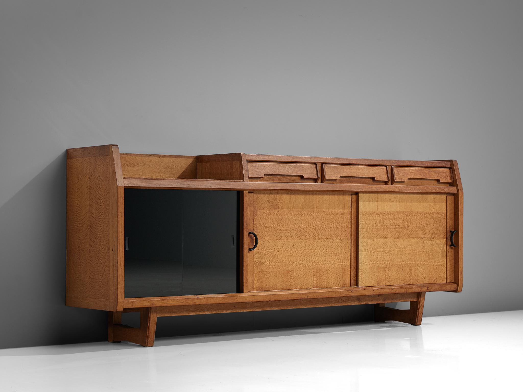 Guillerme et Chambron for Votre Maison, credenza, oak, France, 1960s. 

This well proportioned sideboard is designed by the French designer duo Guillerme and Chambron. The piece is characterized by the solid oakwood and detailed plane divisions. Two