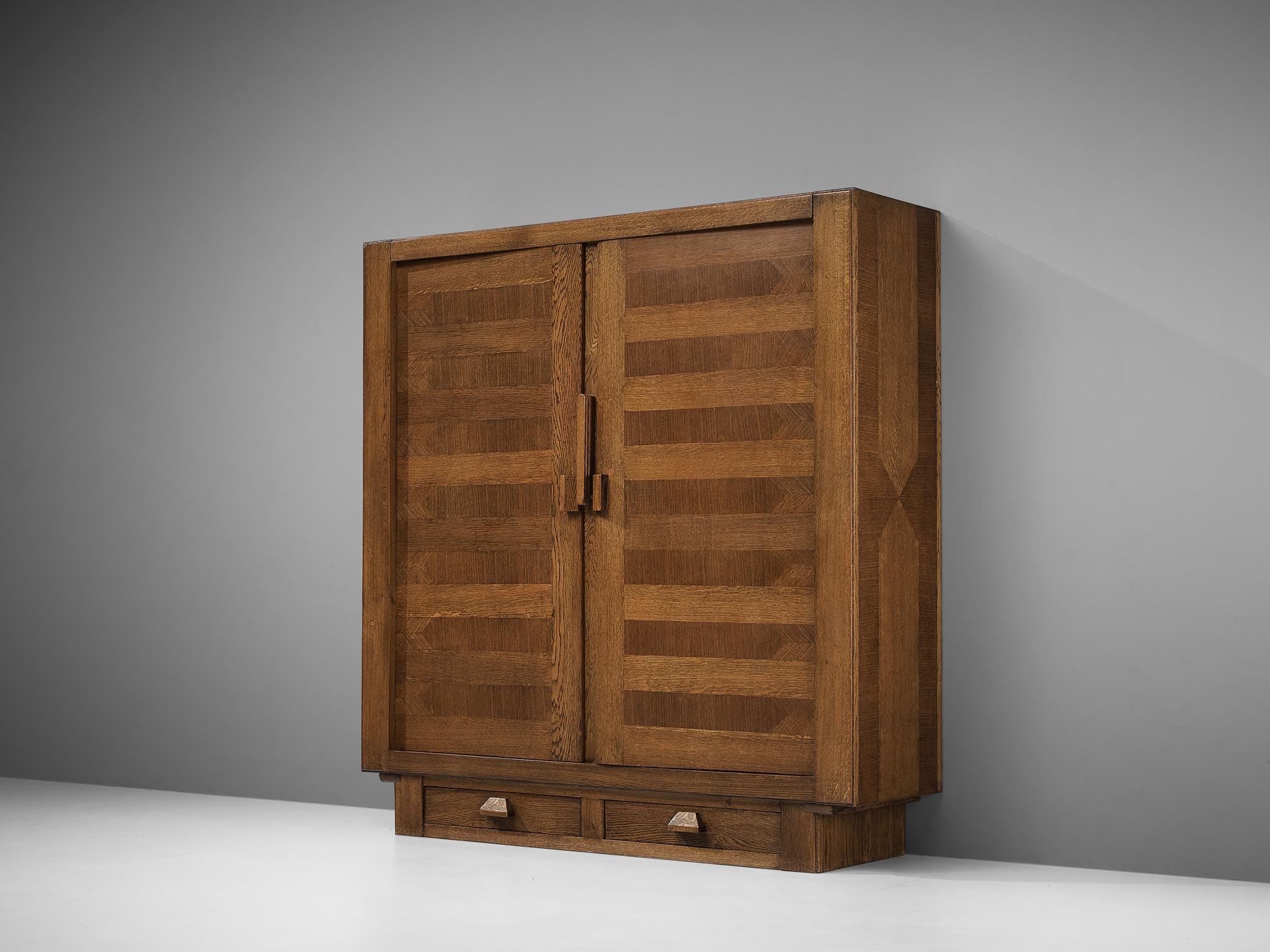 Guillerme et Chambron, amoire, stained oak, France, 1960s

French designer duo Guillerme et Chambron once again proof their great craftsmanship. This cubic wardrobe with two doors and two drawers at the bottom shows geometric inlays that structure