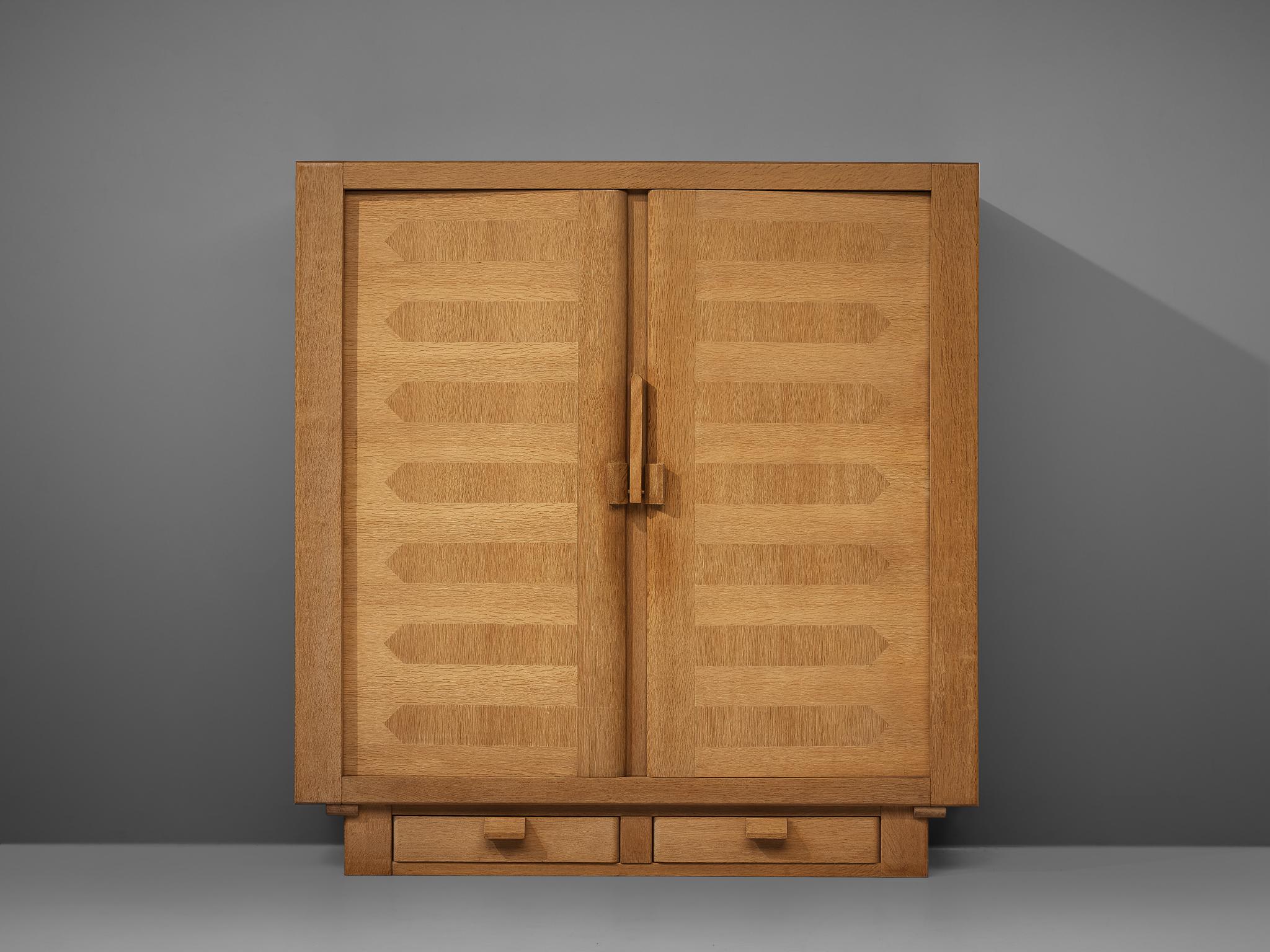 Guillerme et Chambron, amoire, solid oak, France, 1960s

French designer duo Guillerme et Chambron once again proof their great craftsmanship. This cubic wardrobe with two doors and two drawers at the bottom shows geometric inlays that structure