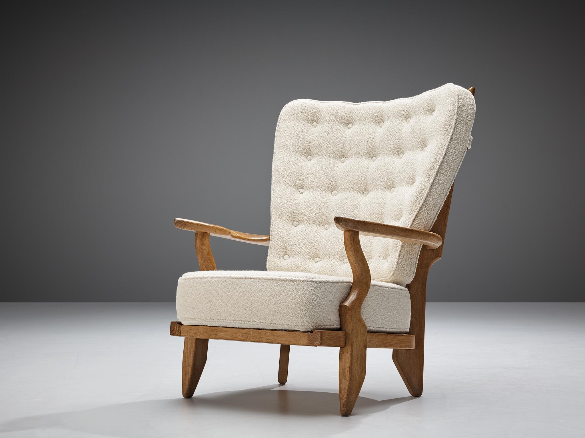 Guillerme et Chambron, customizable 'Grand Repos' lounge chair oak, white woolen Pierre Frey upholstery, oak, France, 1960s.

Guillerme and Chambron are known for their high quality solid oak furniture, from which this is another great example.