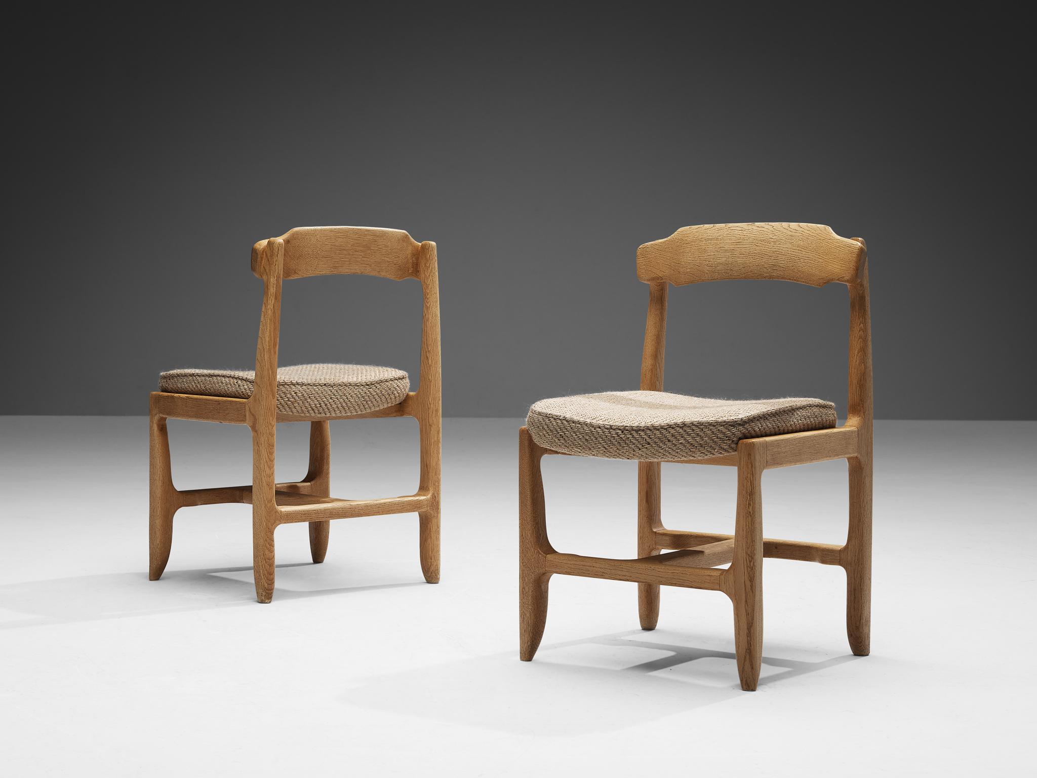 Guillerme et Chambron for Votre Maison, customizable dining chairs, fabric, oak, France, 1960s 

These distinctive chairs in beautifully patinated oak are by the French designer duo Jacques Chambron (1914-2001) and Robert Guillerme (1913-1990).