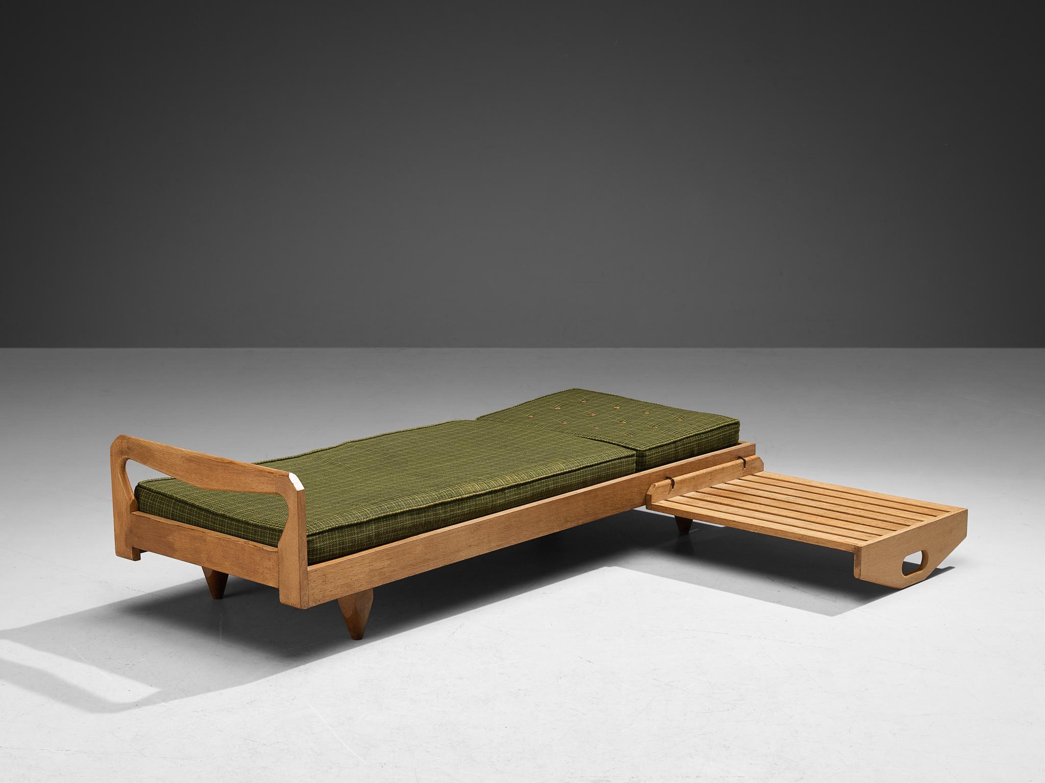 Guillerme et Chambron for Votre Maison, daybed, oak and fabric, France, 1960s.

Sturdy daybed by Guillerme and Chambron executed in solid oak with the typical characteristic decorative details and sculpted forms of the legs. The designs of the