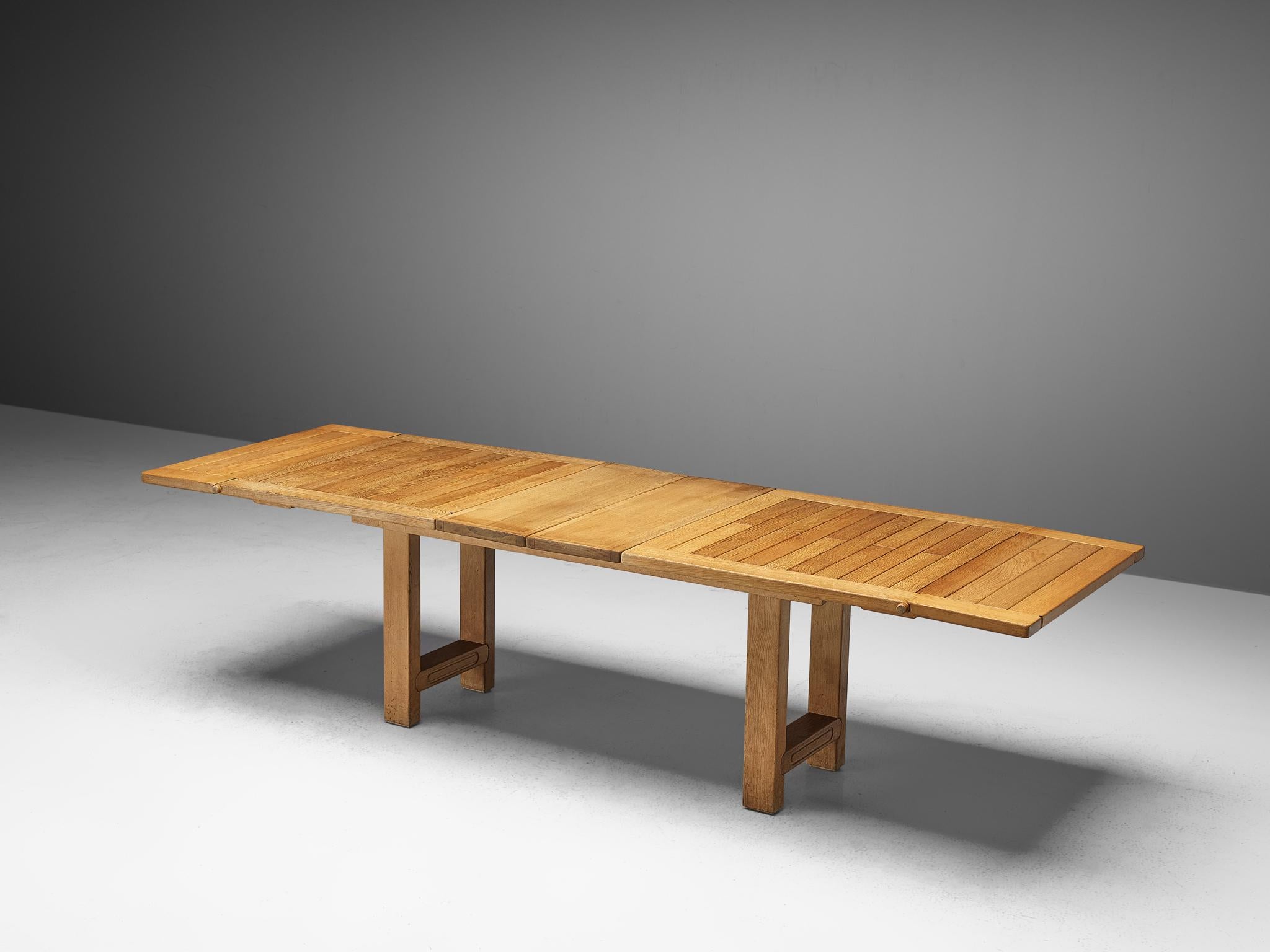 Guillerme et Chambron, dining table 'Bourbonnais', solid oak, France, 1960s

Extendable dining table by French designers Guillerme et Chambron. The table is versatile in the way that it may be extended with two leaves in the middle as well as two