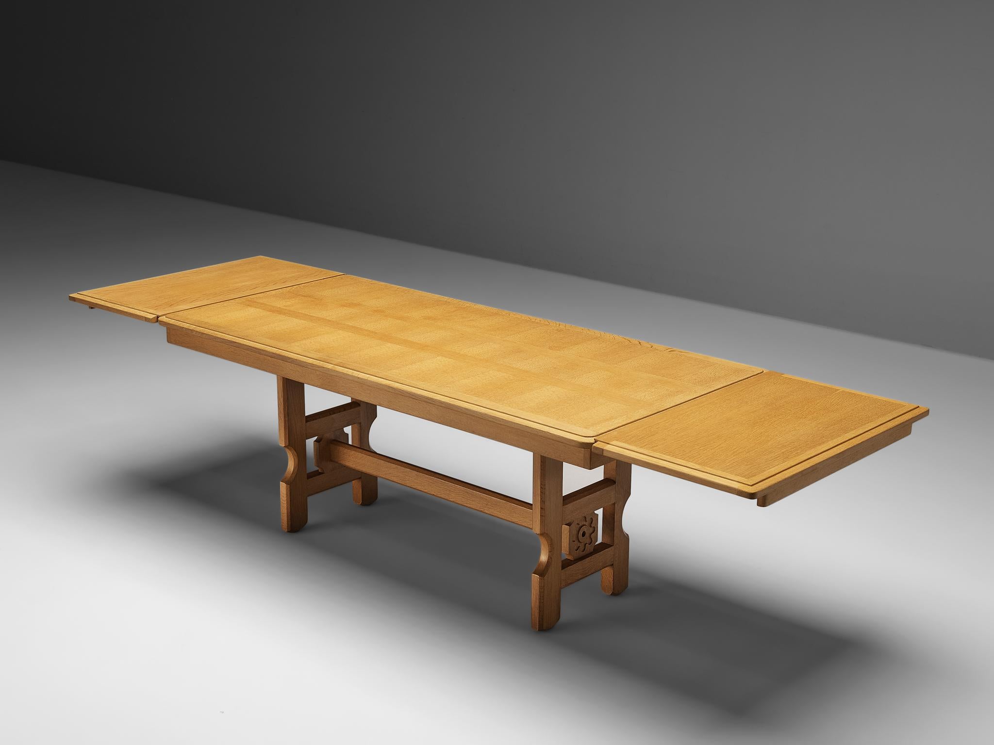 Guillerme et Chambron, extendable dining table, oak, 1960s

Rectangular dining table with inlayed top. This extendable table in solid oak can be extended at both short sides, which makes it a very versatile item. The sculptural base has the