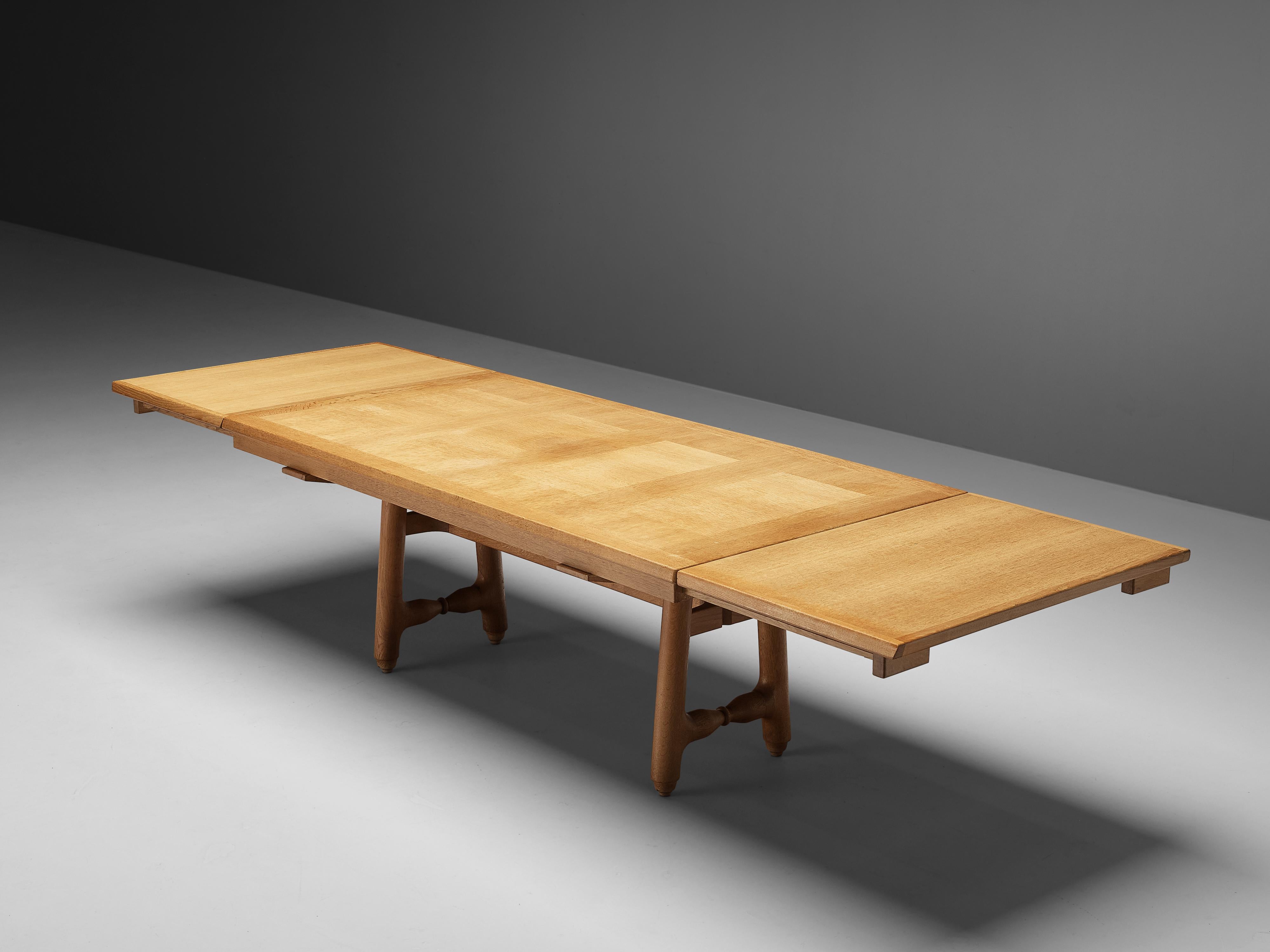 Guillerme et Chambron, dining table, oak, France, 1960s

Extendable dining table with decorative base by Guillerme et Chambron. This table holds a rectangular top with beautiful inlayed woodwork. The extension leaves make the table highly