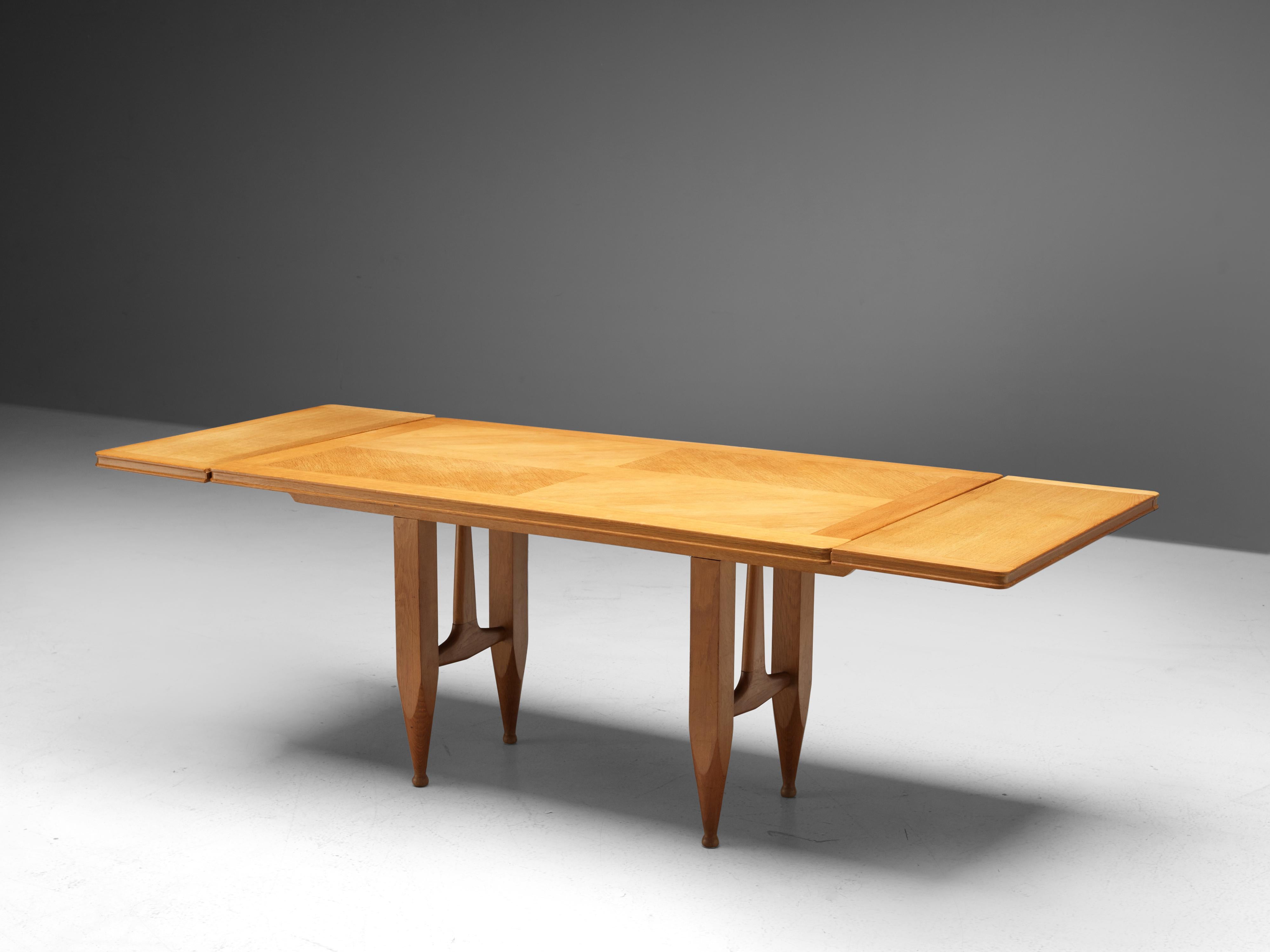 Guillerme et Chambron for Votre Maison, extendable dining table, oak, 1960s

Rectangular shaped dining table with inlayed top. This extendable table in solid oak comes with two optional leaves, which makes it a very versatile item. The sculptural