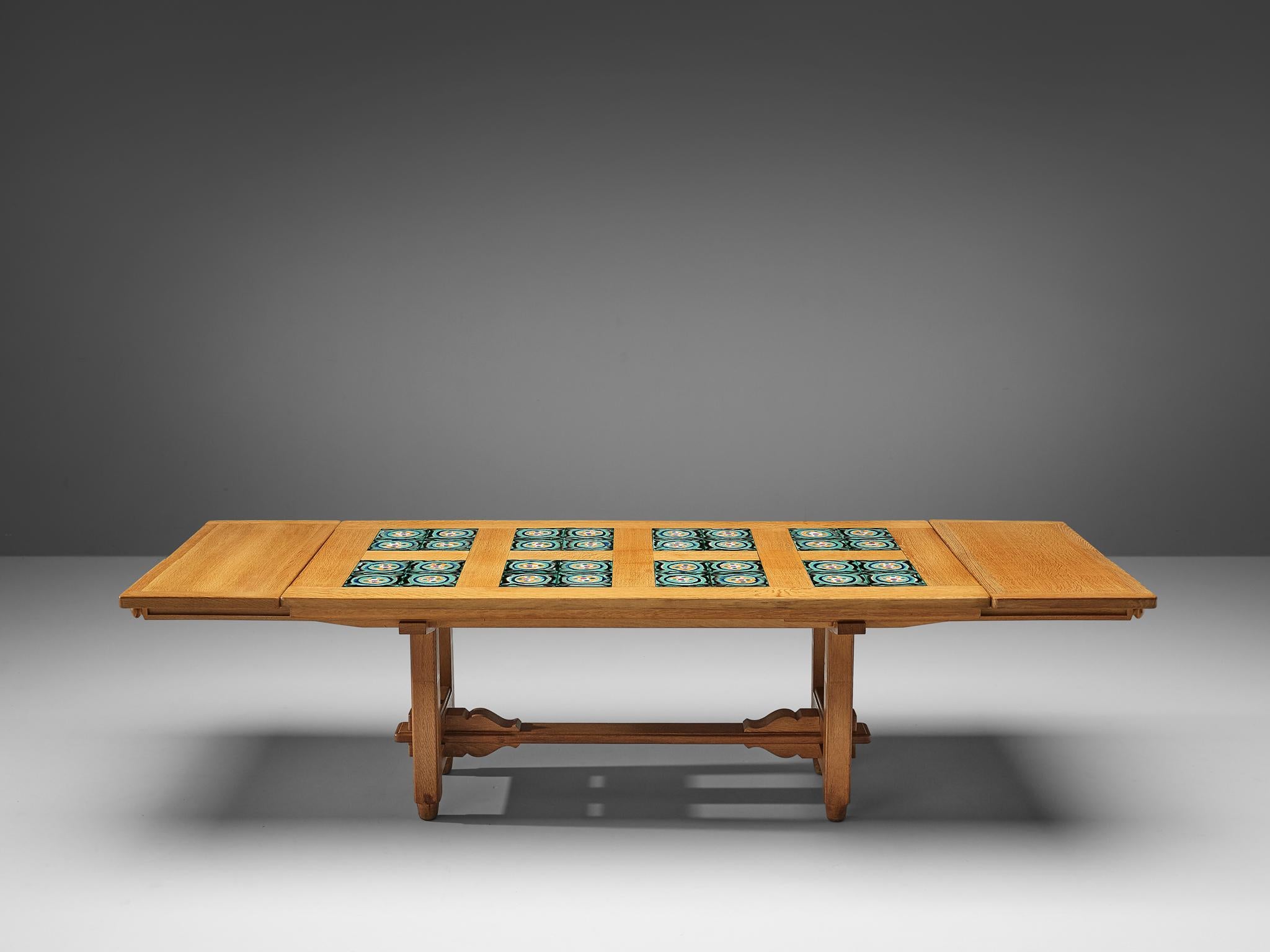 Guillerme et Chambron, extendable dining table, oak, ceramics, France, 1960s

This extandable dining table by Guillerme et Chambron features beautiful ceramic tiles. On the main rectangular tabletop four tiles are combined in eight squared inlays.