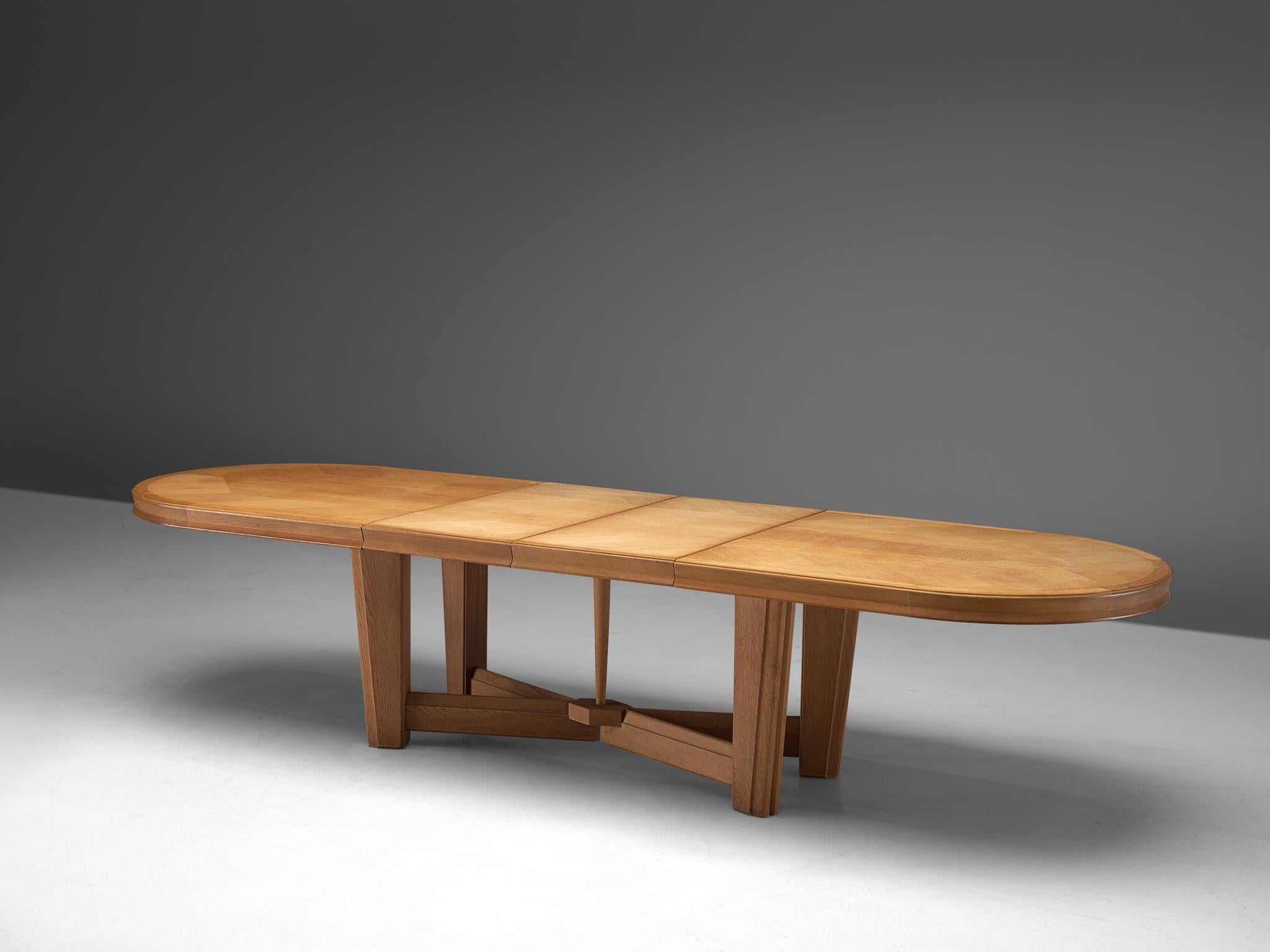 Guillerme et Chambron, extendable dining table, oak, 1960s.

Large oval shaped dining table with inlayed top. This extendable table in solid oak comes with two additional leafs, which add 1m/39inches and makes it a very versatile piece. The