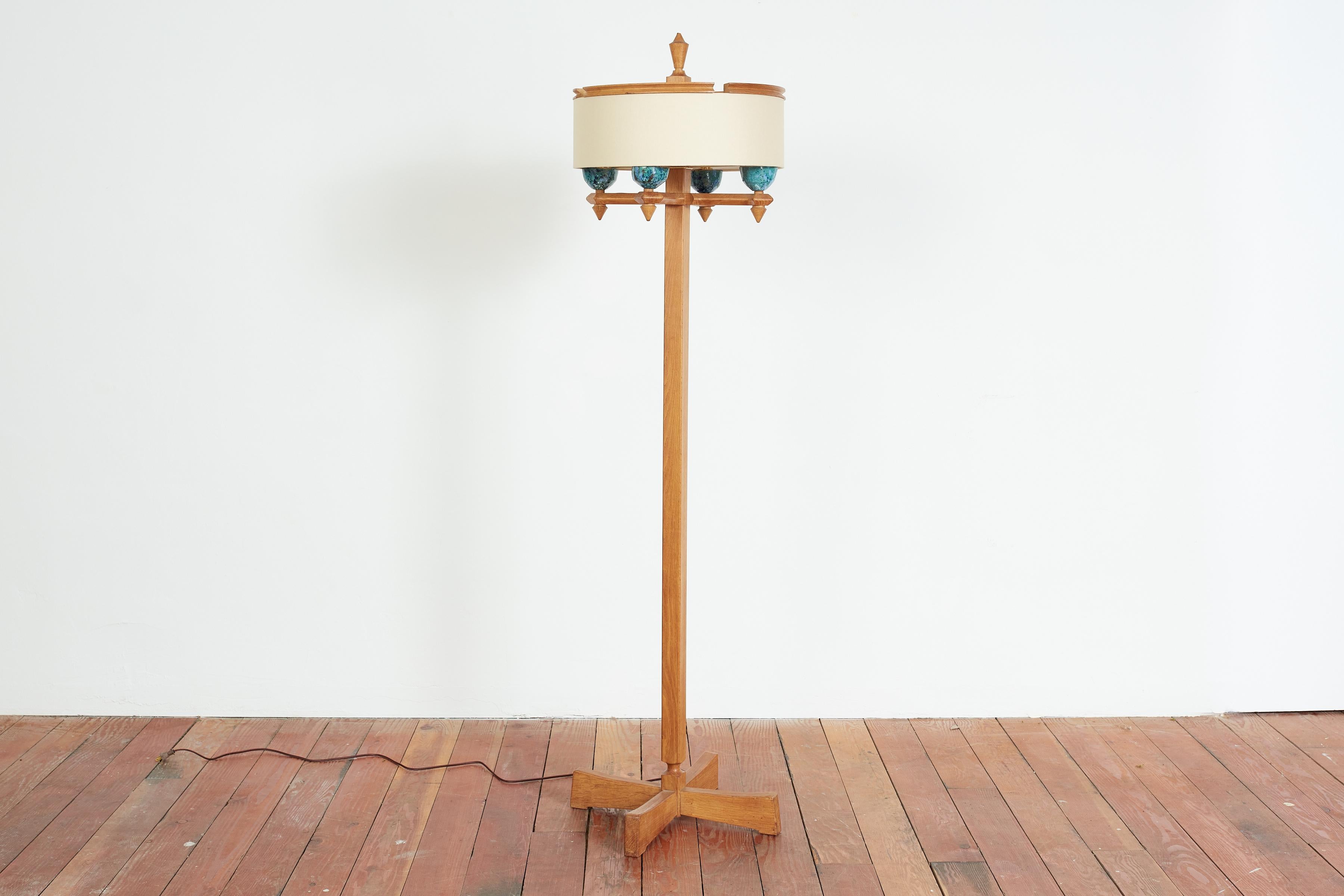 Rare floor lamp by Guillereme et Chambron with tall oak frame and four bright blue signature ceramic sockets. 
New linen shade sits inside the oak rim 
Wonderful piece. 
