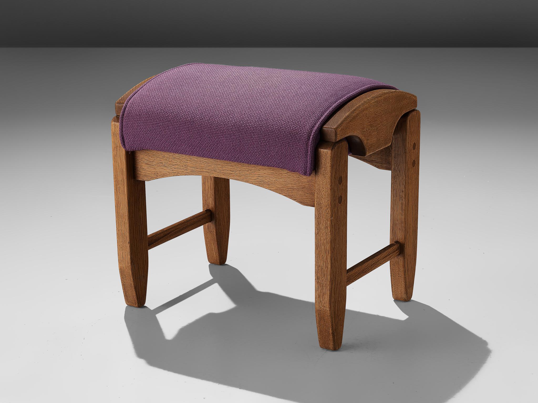 Guillerme et Chambron, stool, oak and fabric, France, 1960s. 

This solid oak wooden footstool with purple color is designed by the French designer duo Guillerme and Chambron. This ottoman has a frame in solid oak with sculptural lines and shapes.