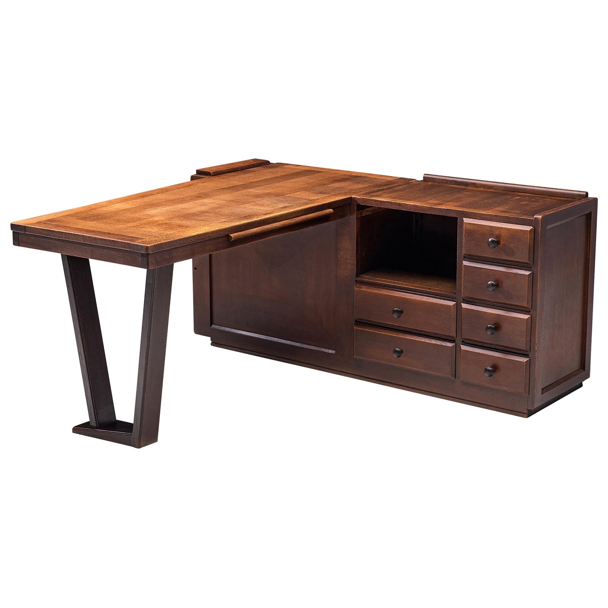 Guillerme et Chambron, corner desk, stained oak, France, 1950s

Corner desk by French designer duo Guillerme and Chambron. This executive desk shows the fine craftsmanship that characterizes the work of this designer duo. The desk consists out of