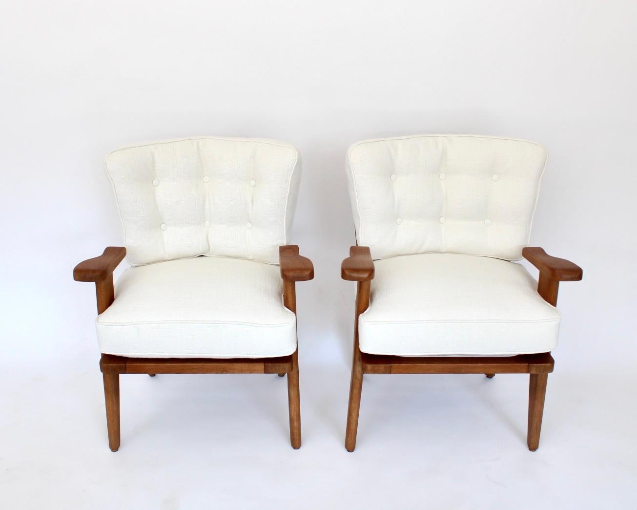 These sculptural French lounge or chairs are designed by Guillerme et Chambron for Votre Maison. 
They are known for their high quality solid oak furniture. 
This comfortable armchair has an interesting open construction, similar to the grand and