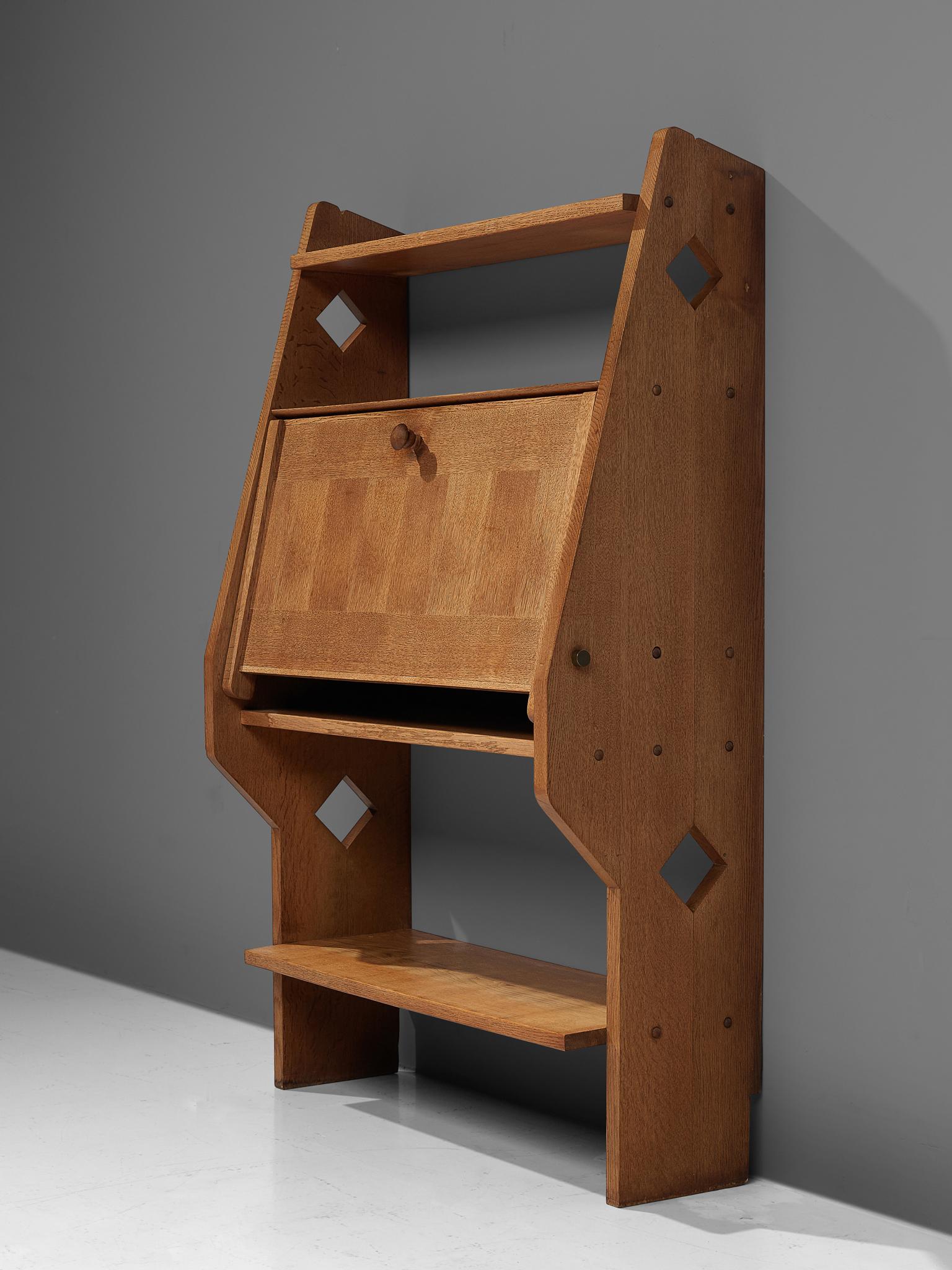 Guillerme et Chambron, secretary, oak, France, 1960s

A solid oak secretary with an inlayed door that flips open and creates a writing space. The sides are have decorative cut outs, typical for the French design duo; Guillerme & Chambron.. This high
