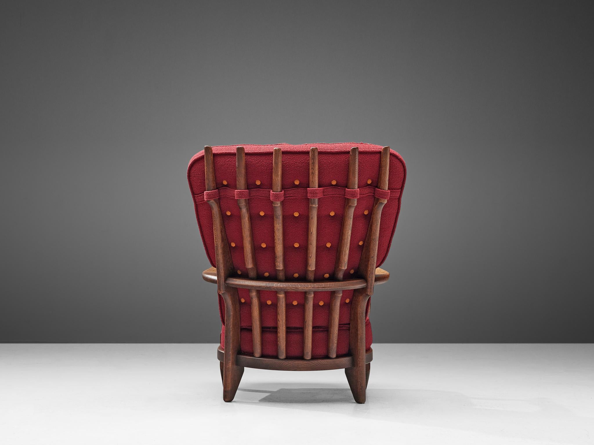 Guillerme et Chambron,'Grand Repos' lounge chair, oak and red textured upholstery, France, 1960s.

Guillerme and Chambron are known for their high quality solid oak furniture, from which this is another great example. This chair with a high back