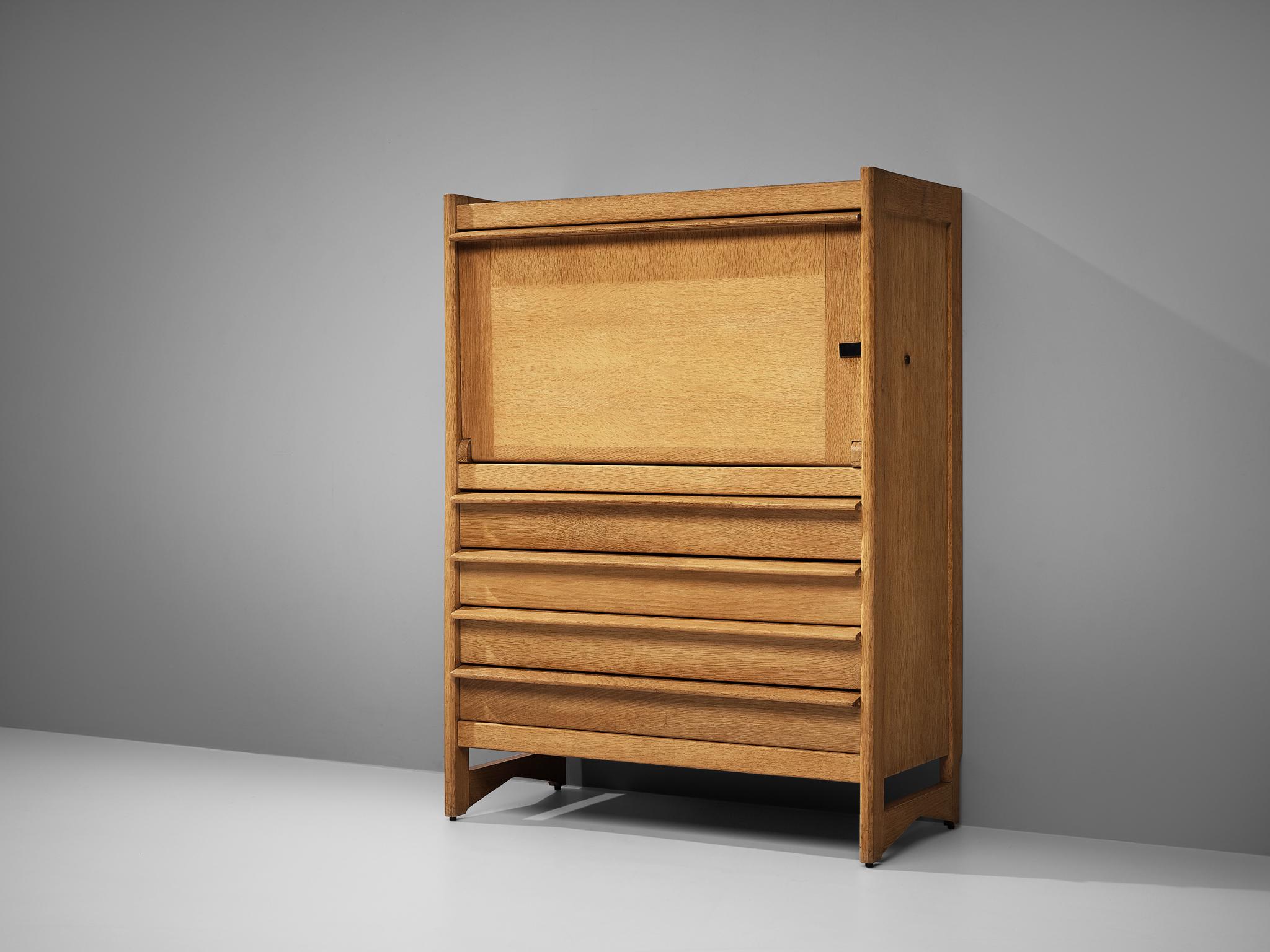 Guillerme et Chambron, highboard, oak, metal, France, 1960s

Guillerme et Chambron designed this beautiful yet functional highboard in the 1960s. Four drawers and a hinge door opening downwards offering structured storage space provide the user with