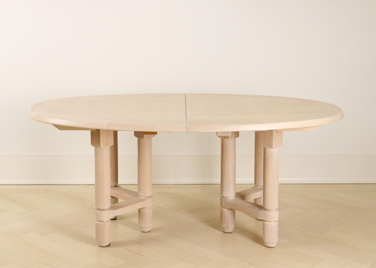 An extendable limed oak dining table. At its shortest (as pictured) it is 72