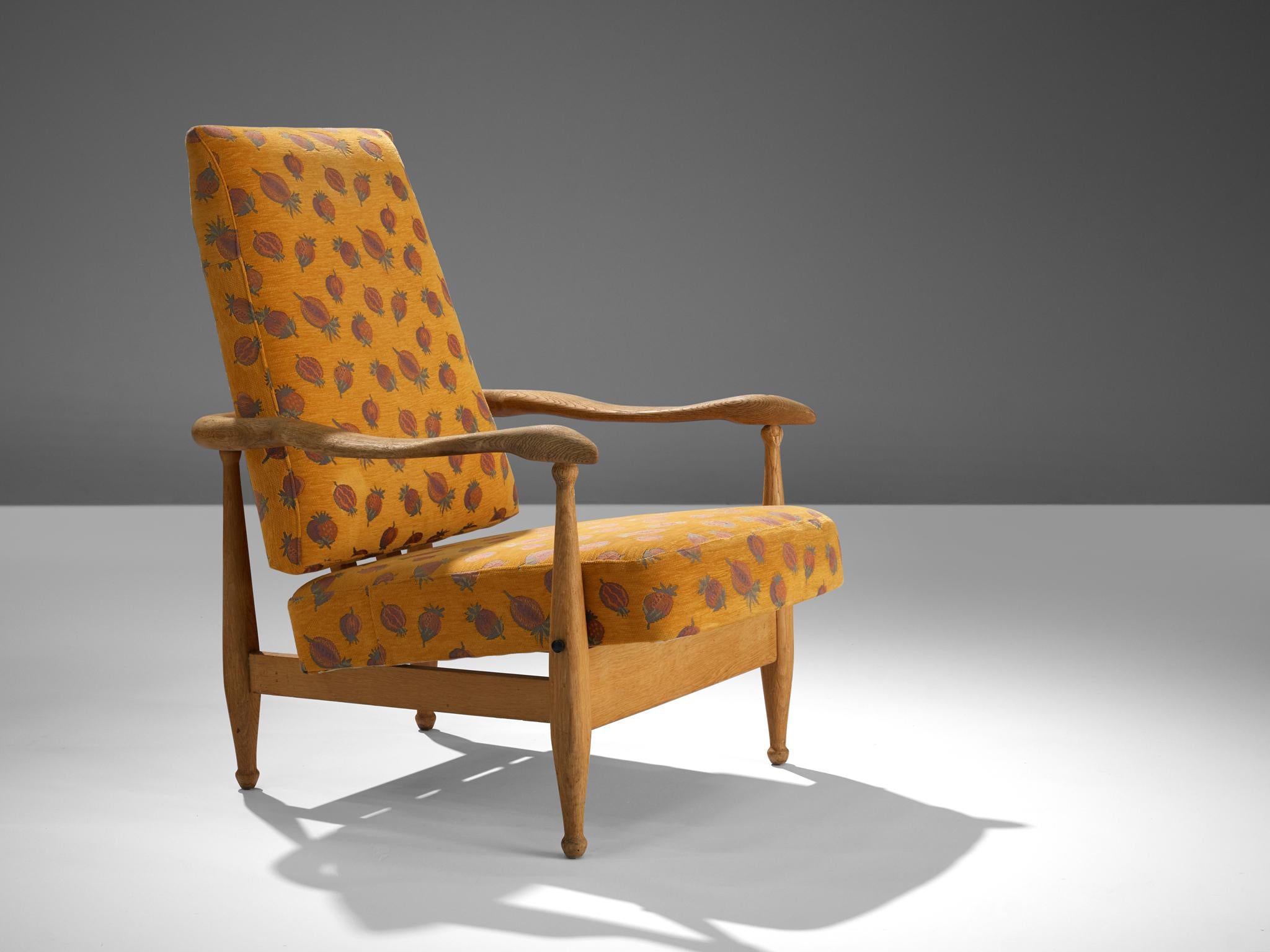 Guillerme et Chambron, lounge chair 'Dagobert'/'Air France', orange patterned upholstery, oak, France, 1960s.

Guillerme and Chambron are known for their high quality solid oak furniture, of which this lounge chair is another great example. It has