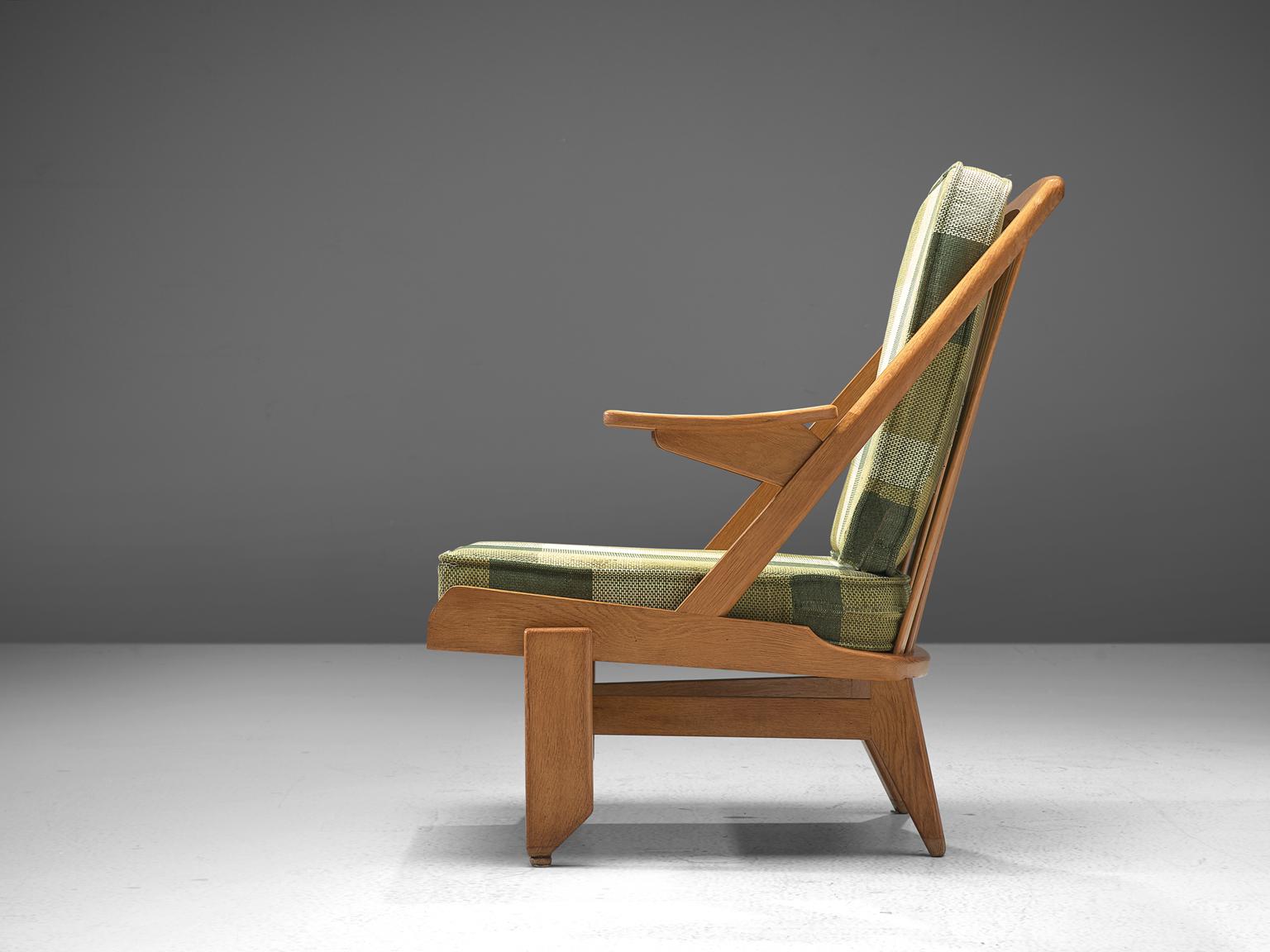 Guillerme and Chambron, lounge chair, green checkered fabric and oak, France, 1950s. 

This French designer duo is known for their extreme high quality solid oak furniture, from which this lounge chair is another great example. This chair has a very
