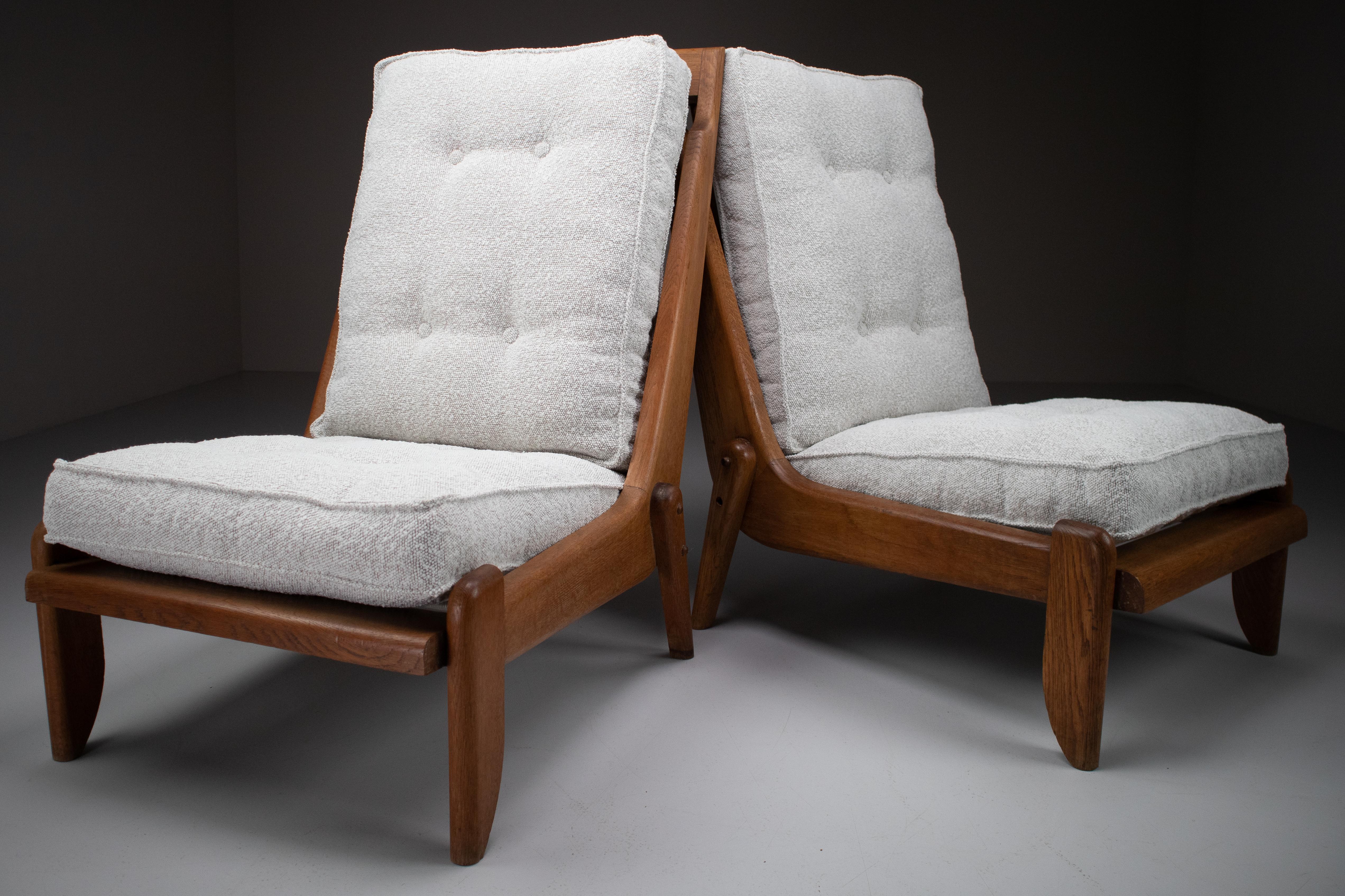 Guillerme & Chambron, pair of two lounge chairs in solid blond oak and reupholstered in bouclé fabric. 

Pair of two original midcentury lounge chairs manufactured and designed by Guillerme & Chambron in France, 1950s. Made of solid blond oak and
