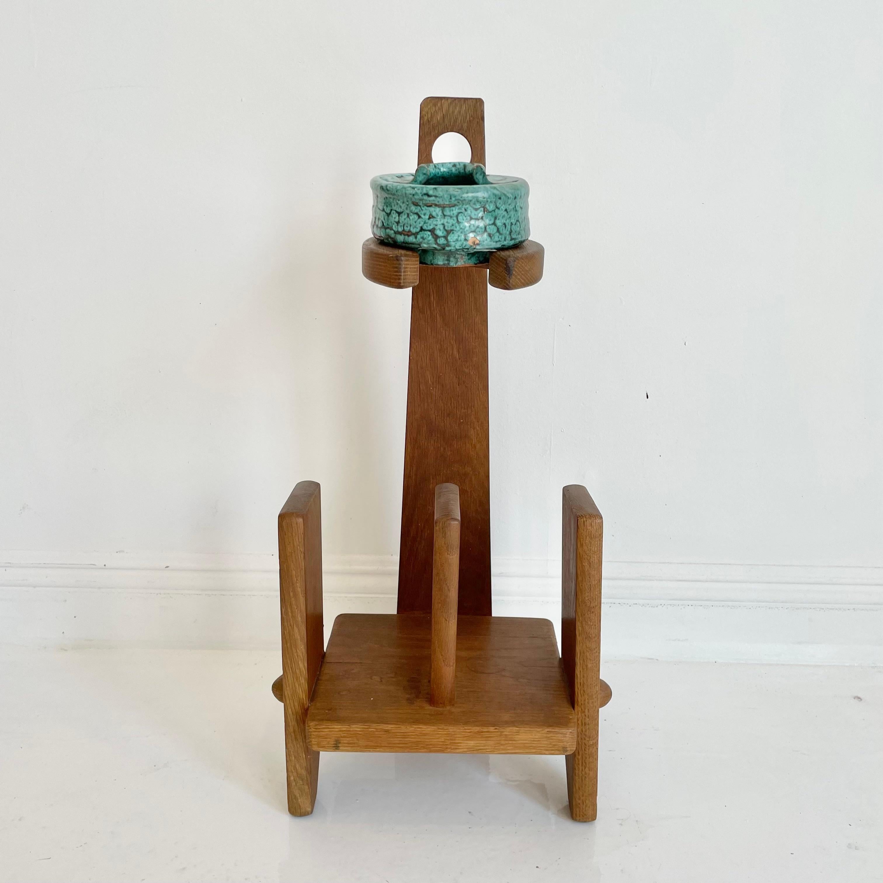 Stunning French magazine rack by designers Guillerme et Chambron. Made of oak. Beautiful, original ceramic ashtray. Very rare find. Gorgeous design. Perfect accessory for a larger Guillerme et Chambron chair, settee or cabinet.