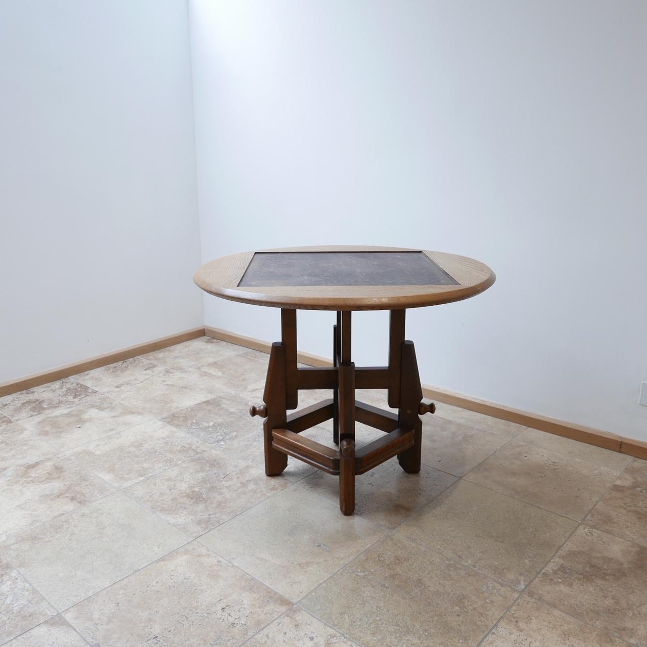 French, midcentury adjustable coffee to dining table,

circa 1960s by design legends Guillerme et Chambron.

Oak, originally would have had ceramics, these are lacking so can be replaced with mirrored glass, marble, smoked glass etc. to