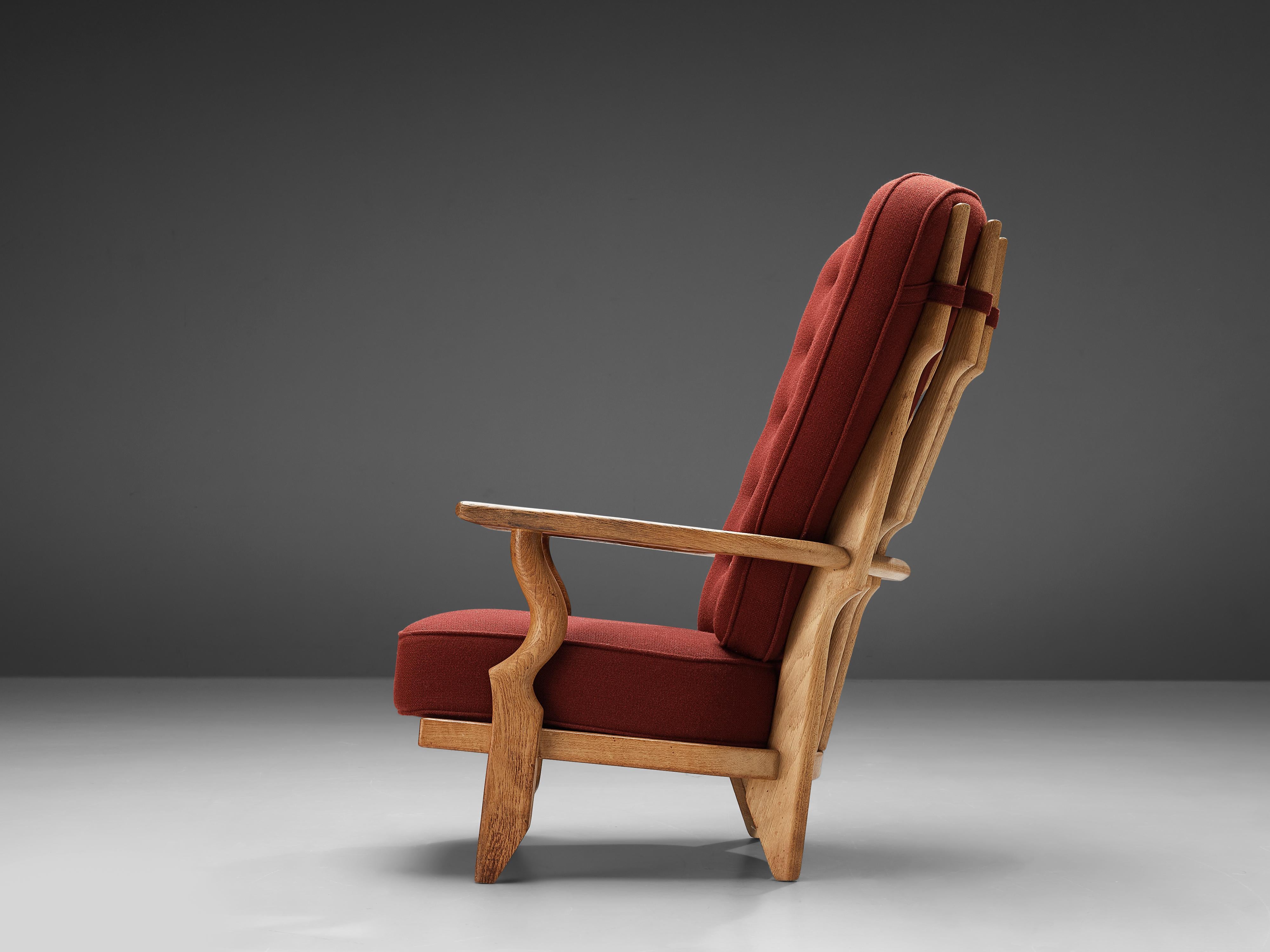 Guillerme et Chambron, 'Mid' Repos lounge chair, oak, red upholstery, France, 1960s

The chair has an interesting, sculptural shape, the legs and armrests blend over into each other creating a gap between the seat and the armrest. The carved edges