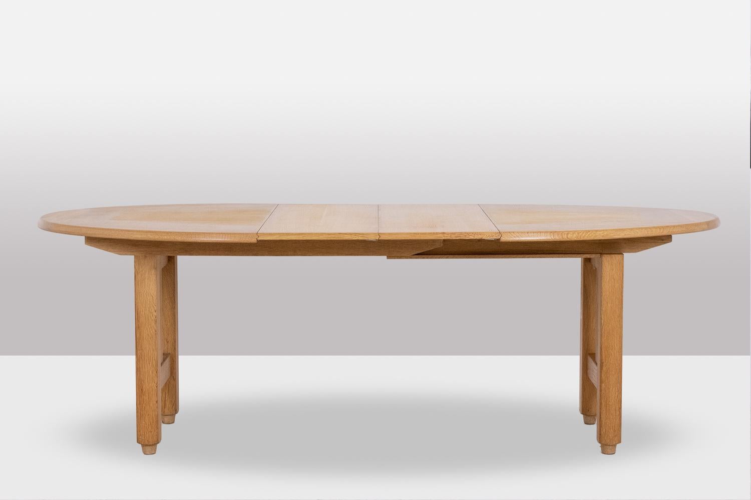 Jacques Chambron and Robert Guillerme for Votre Maison.

Oval-shaped table in natural blond oak resting on four legs, with two oak extensions, allowing to placed 4 or 6, allowing 4 or 6 people to be placed around.

French work realized in the
