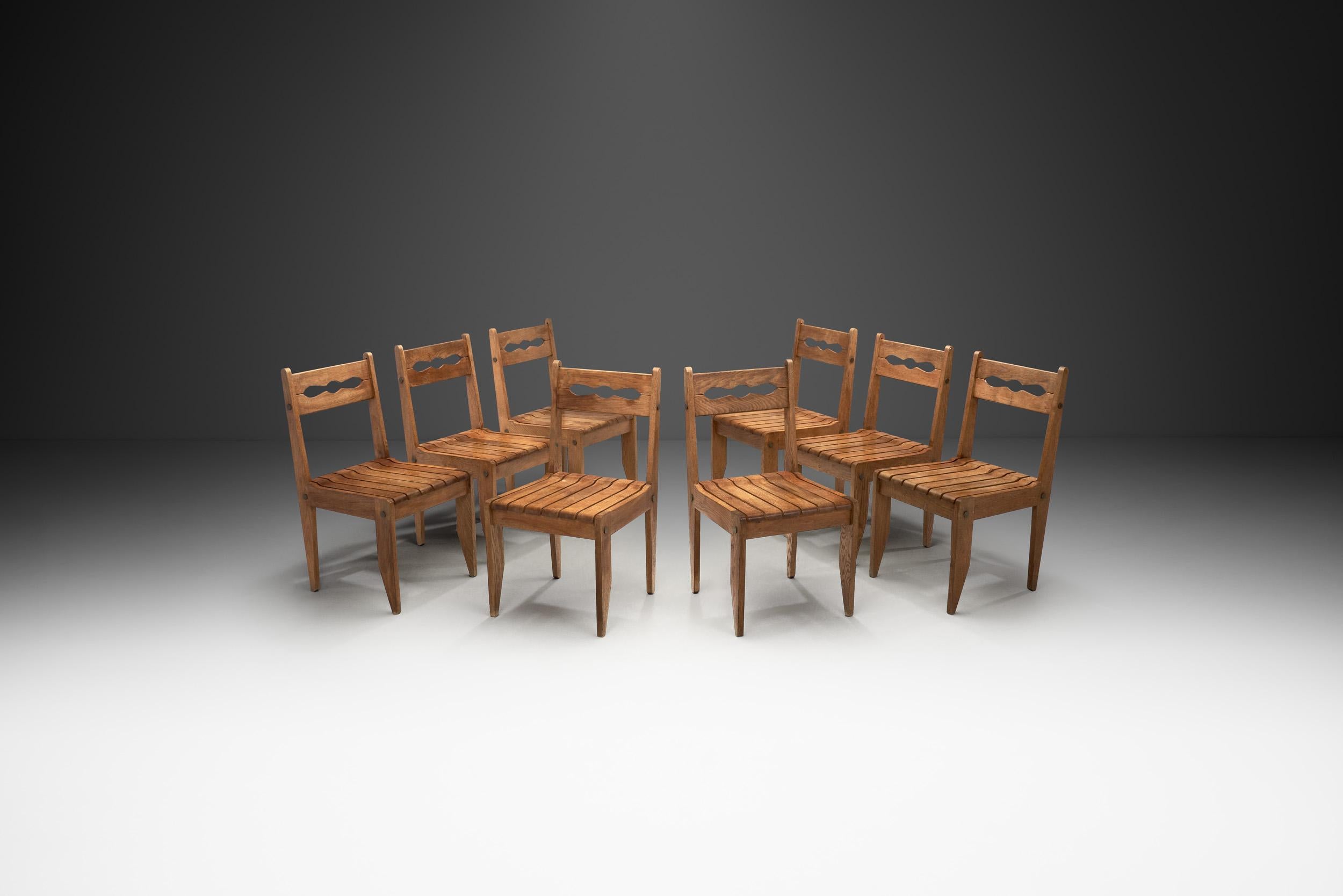This rare set of eight chairs by the French designers, Guillerme et Chambron, has an elegant appearance combined with distinctive, rustic design elements. Beyond its aesthetic quality, this set is also a testament to the duo’s famous craftsmanship