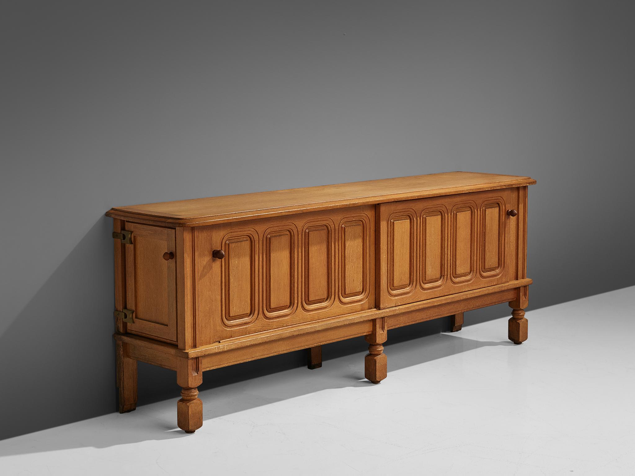 Guillerme et Chambron for Votre Maison, credenza, in oak and ceramic, France, 1960s.

Characteristic sideboard in solid oak. This cabinet holds the characteristics of the French designer duo Jacques Chambron and Robert Guillerme. As many of the
