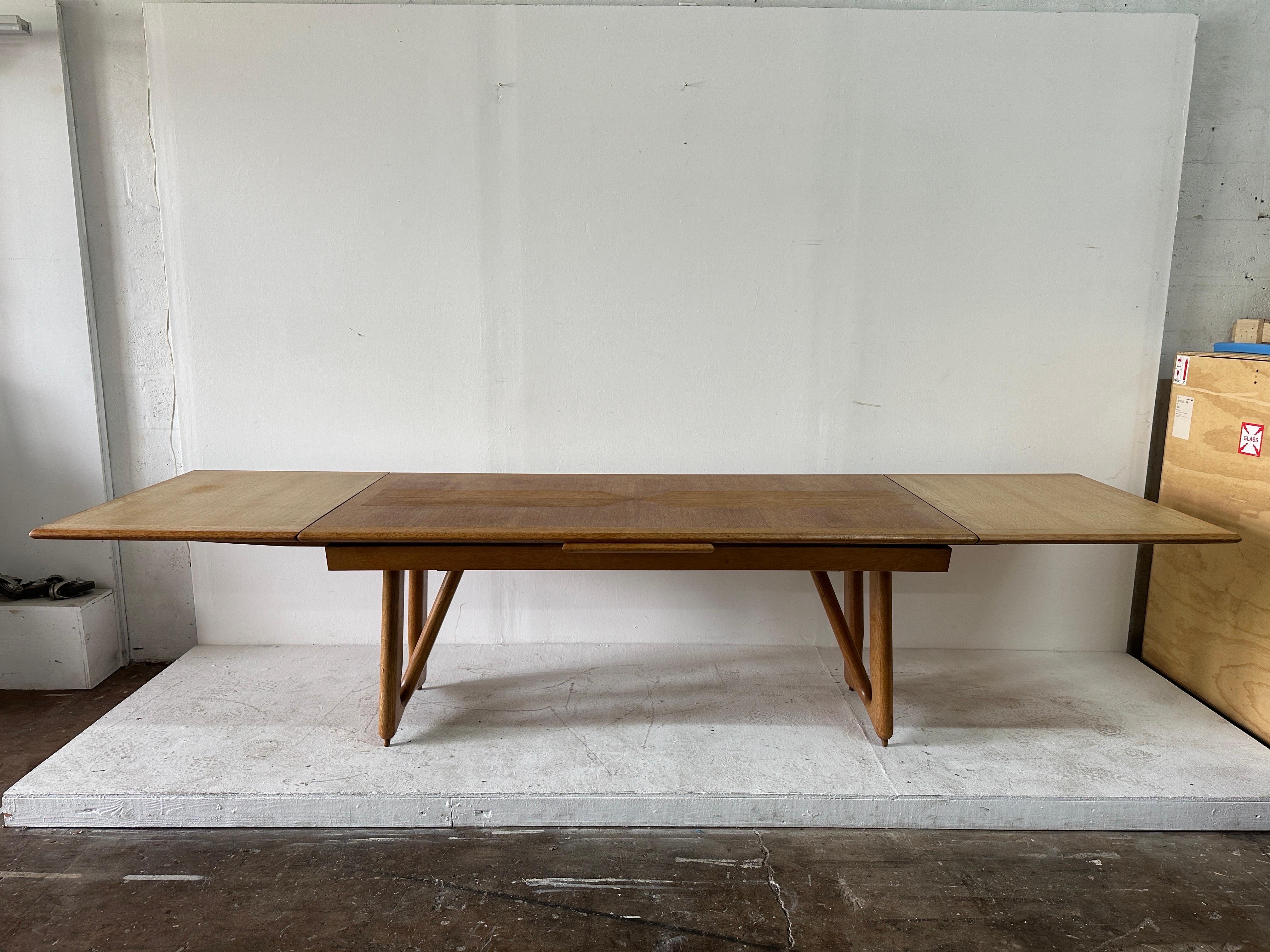 Guillerme et Chambron for Votre Maison, dining table, oak, France, 1965.  Dimensions of table with FULL extension is 125.5 inches. This extendable dining table in solid oak by French designers Guillerme and Chambron. This elegant table shows