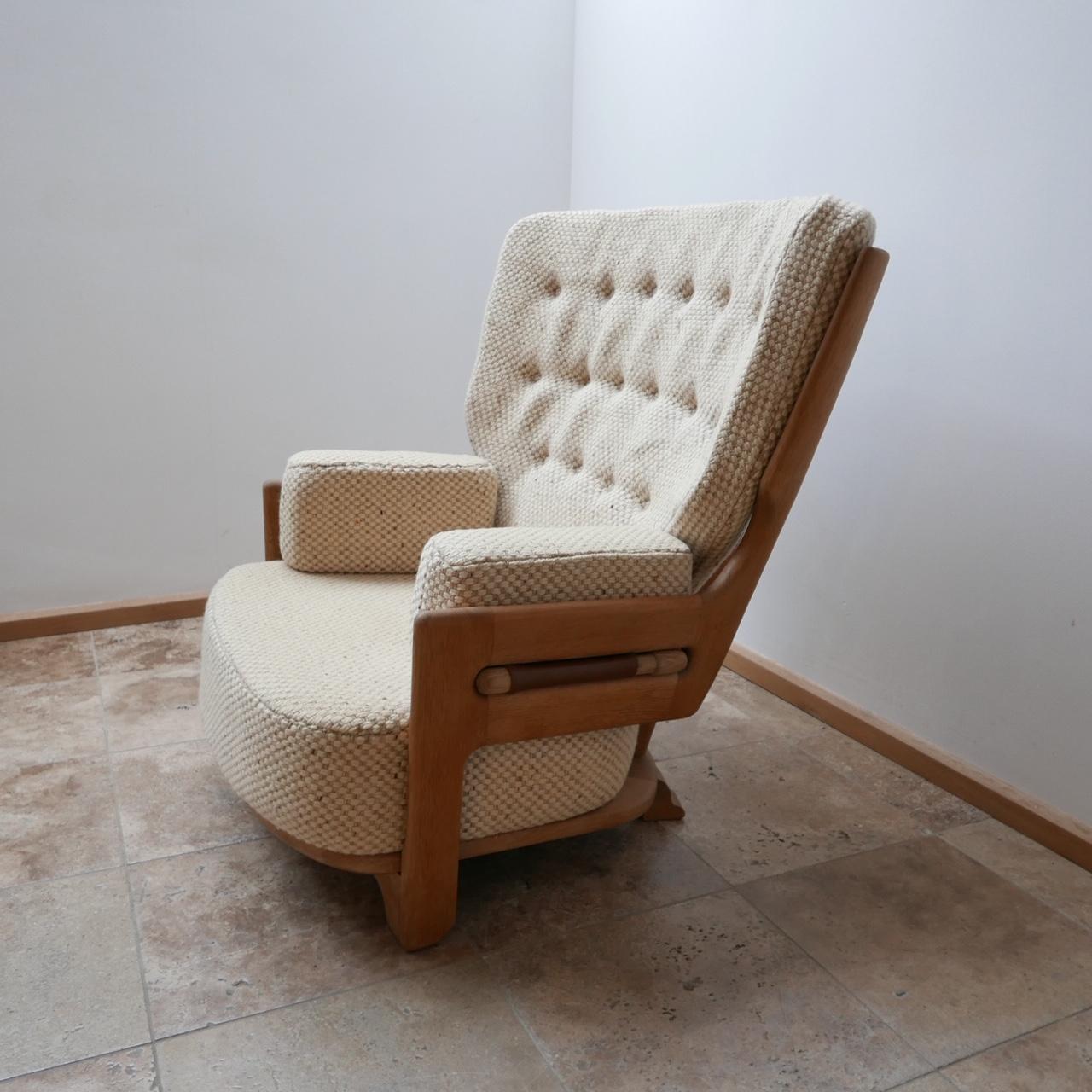 A large comfy armchair by Guillerme et Chambron. 

French, circa 1960s. 

Solid oak, leather straps and upholstery. 

Original upholstery, which can be updated. 

Rare Denis model.

Dimensions: 102 width x 85 depth x 35 seat height x 98