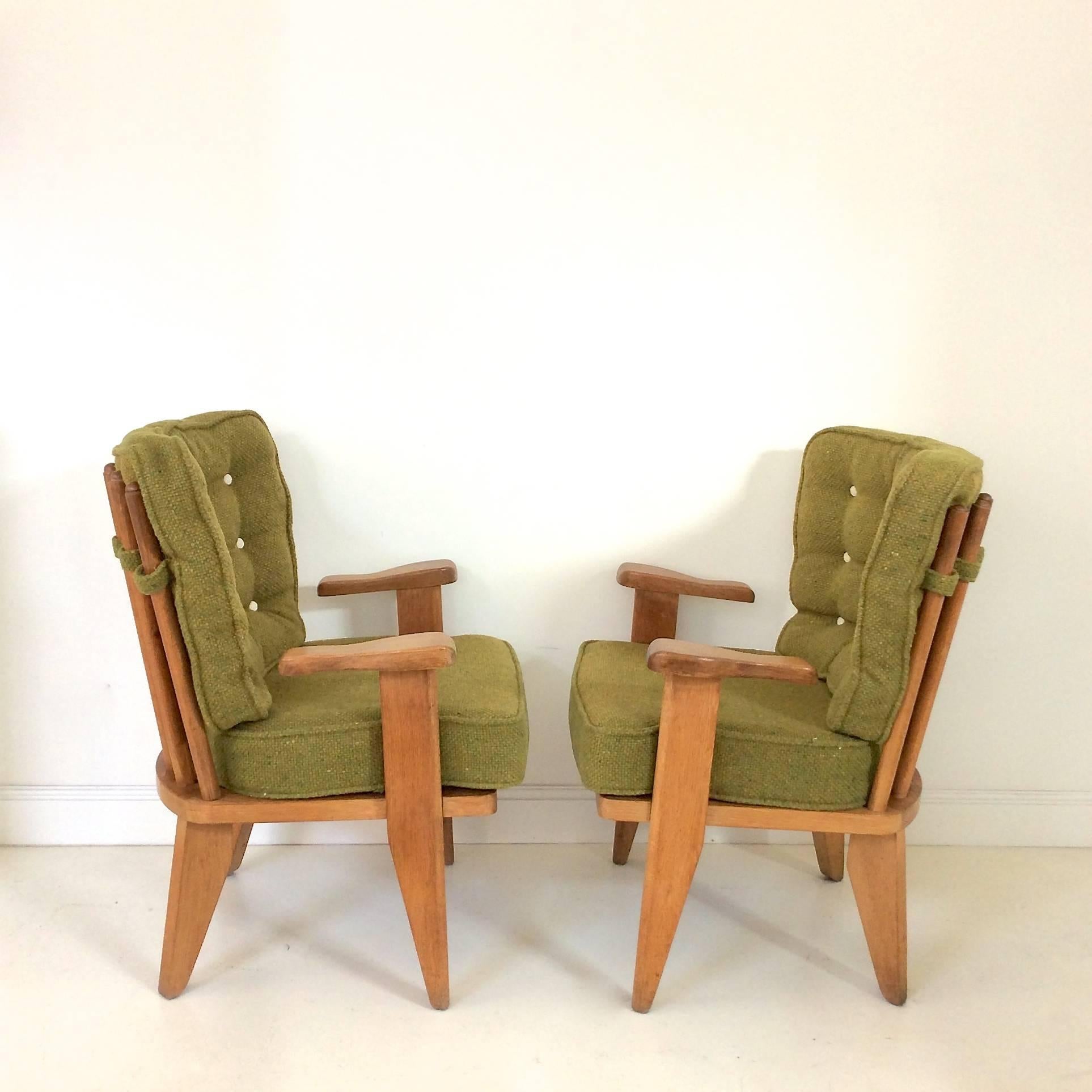 Nice Guillerme et Chambron armchairs, Votre Maison Edition, circa 1950, France.
Carved solid oak, floating arms, curvy spindles back.
Original green wool fabric in very good condition.
Dimensions: 90 cm H, 46 cm seat height, 70 cm W, 60 cm D.
 