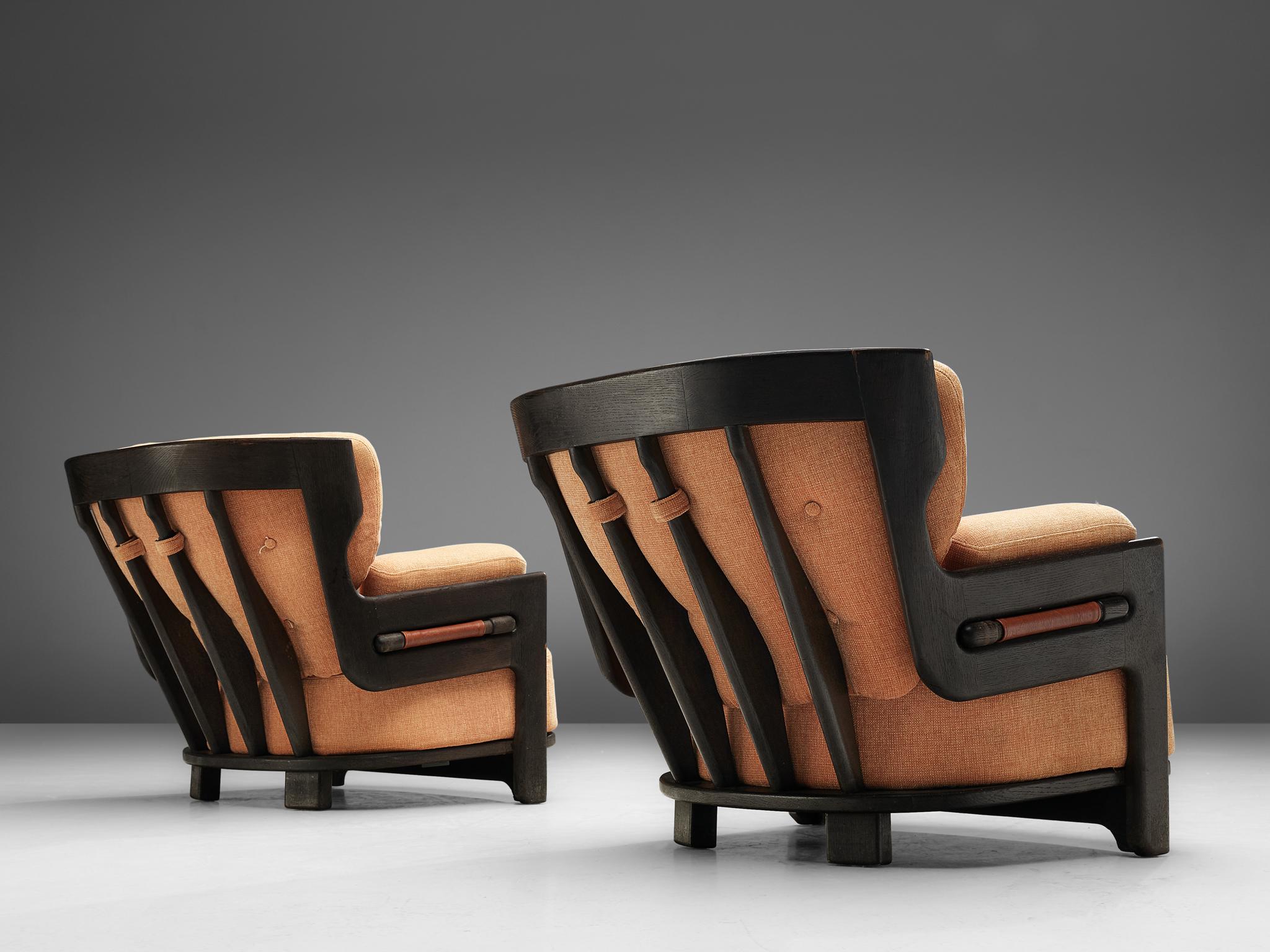 Guillerme & Chambron for Votre Maison, set 2 of 'Denis' lounge chairs, fabric and oak, France, 1960s.

Set of two extraordinary Guillerme and Chambron lounge chairs in darkened, solid oak with the typical characteristic decorative details at the