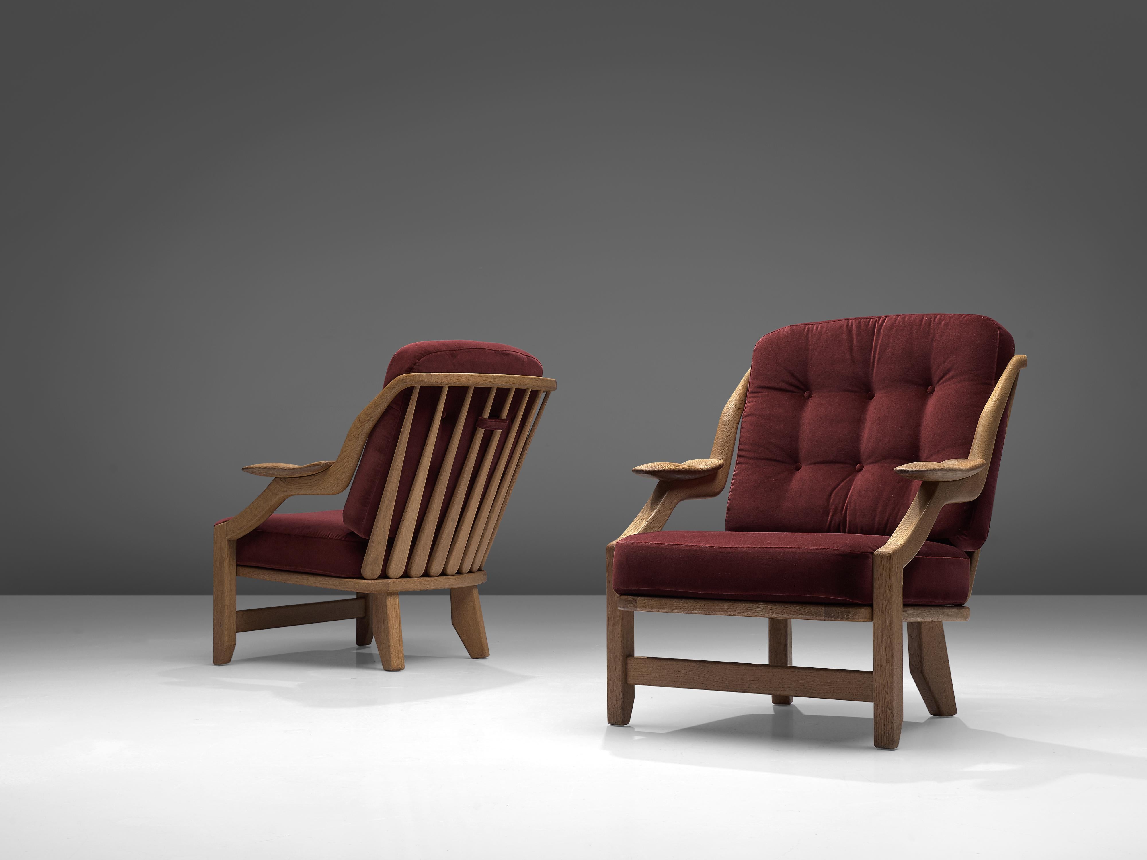 Guillerme et Chambron, pair of lounge chairs model 'Gregoire', burgundy fabric, oak, France, 1950s

This French designer duo is known for their extreme high quality solid oak furniture, from which this set is another great example. These chairs have