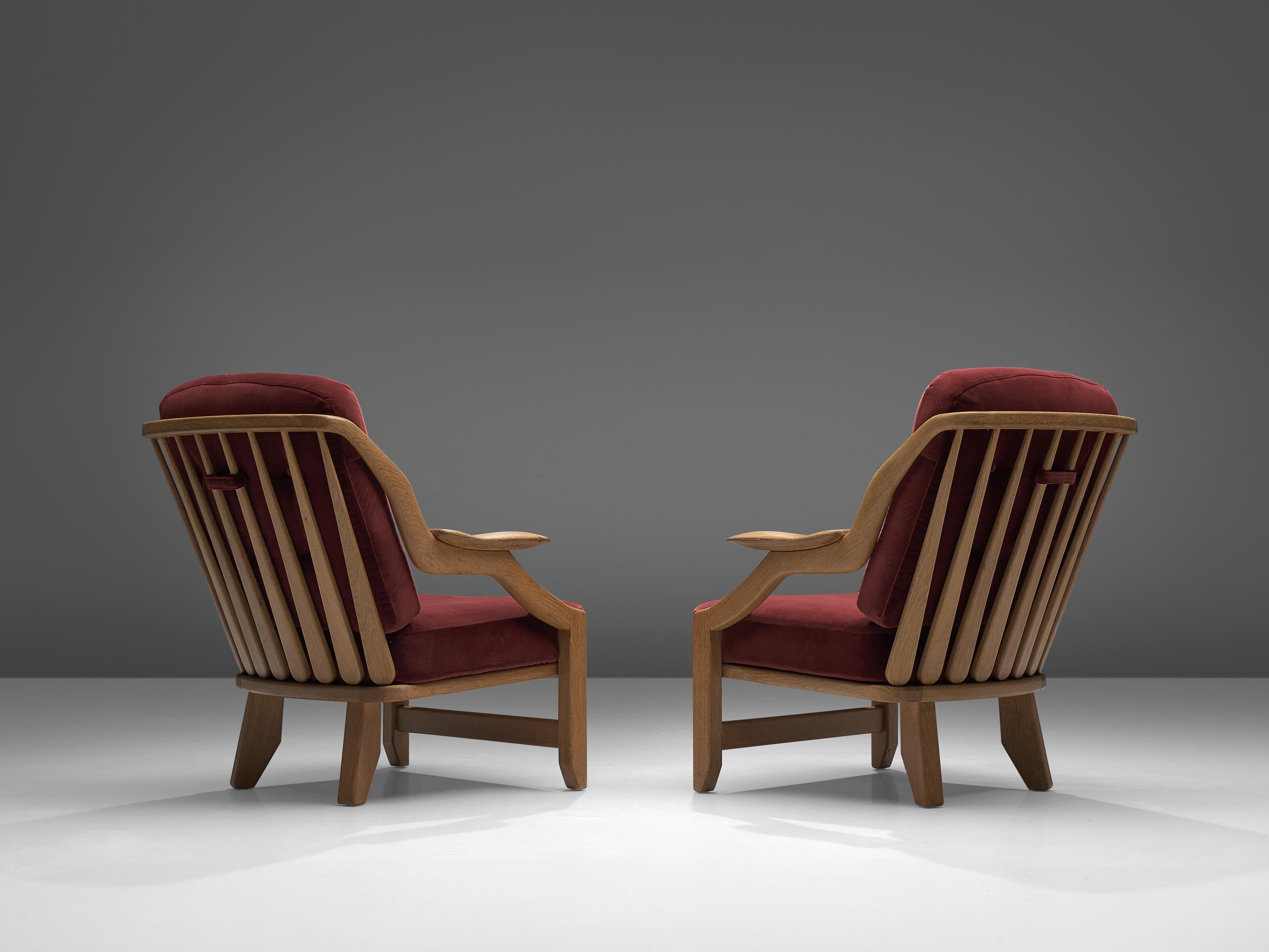 French Guillerme et Chambron Pair of 'Gregoire' Lounge Chairs in Burgundy Upholstery