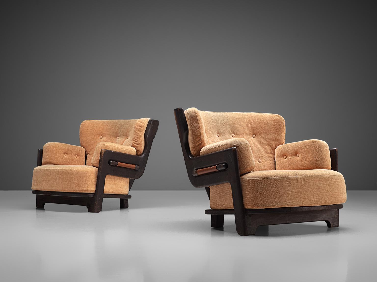 Guillerme & Chambron for Votre Maison, set 2 of 'Denis' lounge chairs, fabric and oak, France, 1960s.

Set of two extraordinary Guillerme and Chambron lounge chairs in darkened, solid oak with the typical characteristic decorative details at the