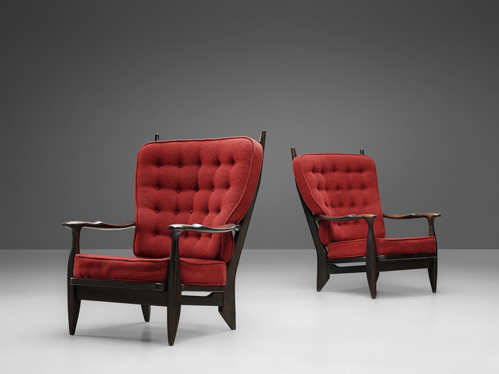 Guillerme et Chambron, lounge chairs, oak, red upholstery, darkened oak, France, 1960s.

Guillerme and Chambron are known for their high quality solid oak furniture, of which these two lounge chairs are another great example. These chairs have an