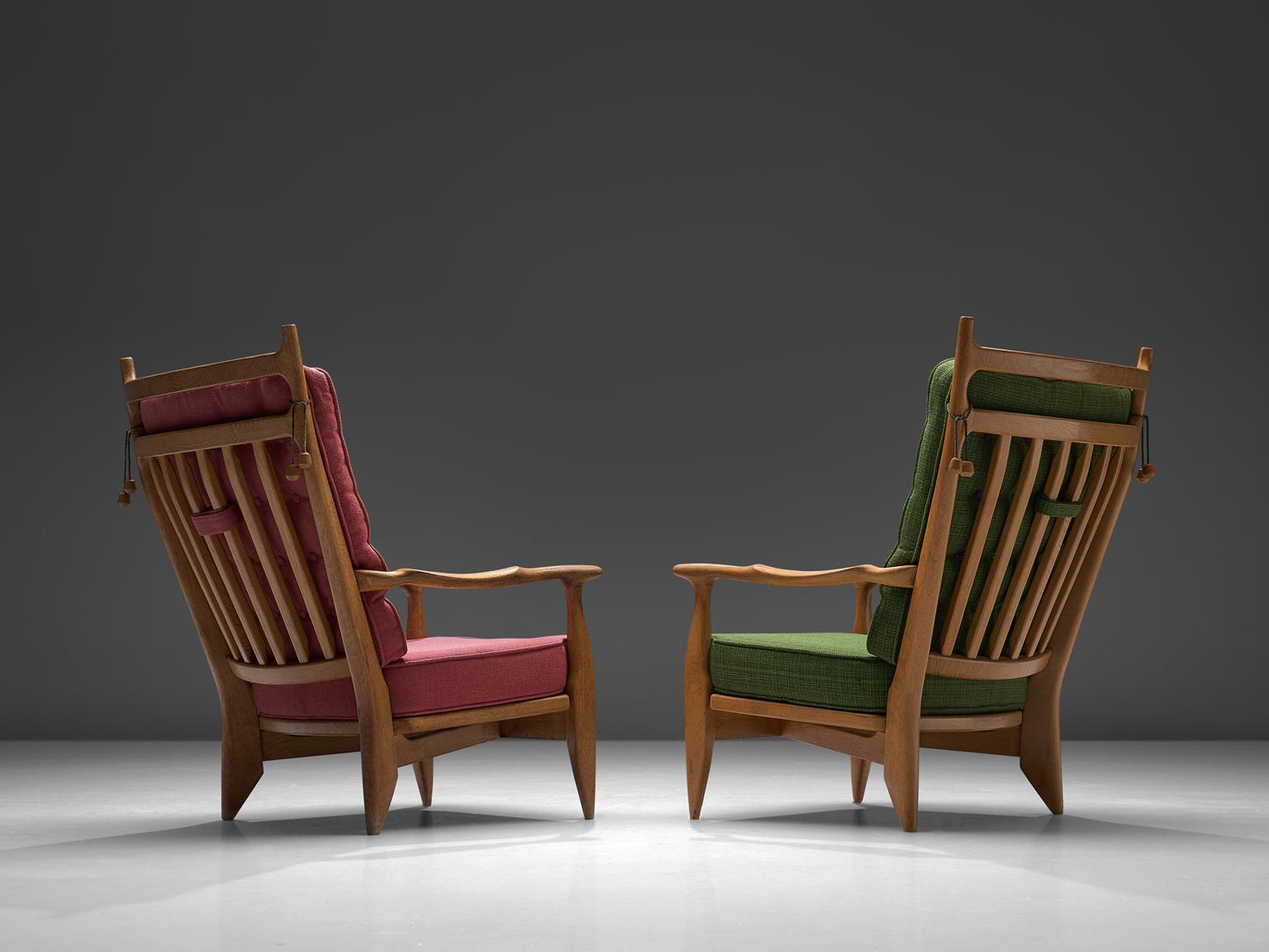 Guillerme et Chambron, set of 2 lounge chairs oak, pink and green upholstery, oak, France, 1960s. 

Guillerme and Chambron are known for their high quality solid oak furniture, of which these two lounge chairs are another great example. These