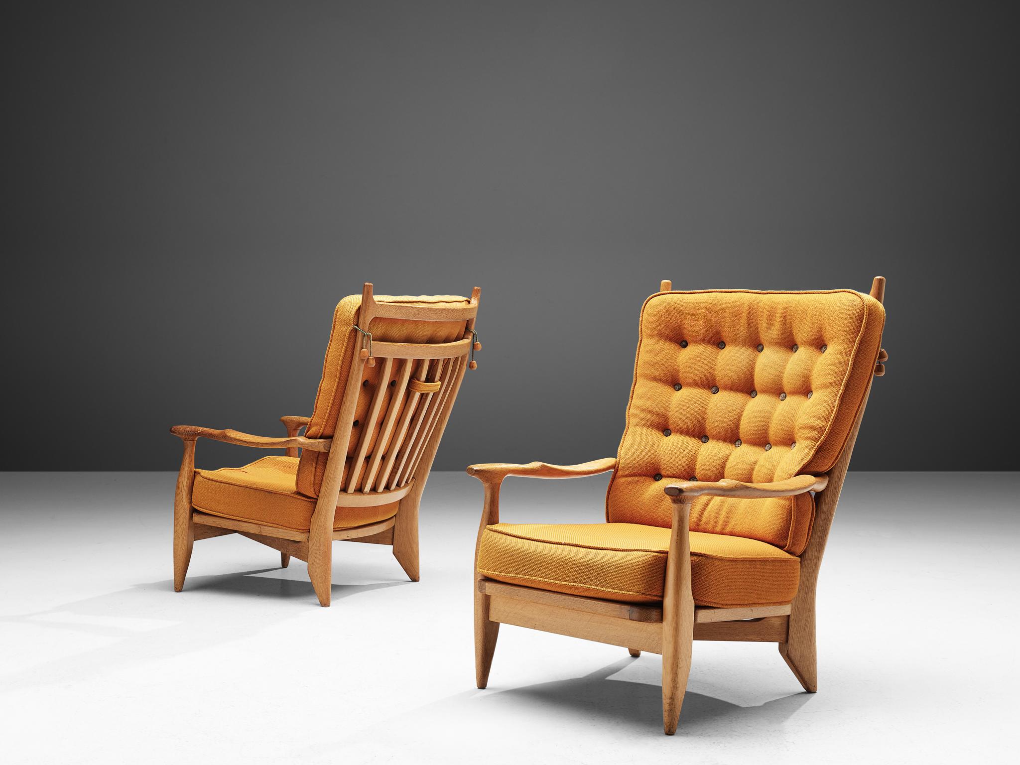 Guillerme et Chambron, set of two lounge chairs oak, yellow upholstery, oak, France, 1960s. 

Guillerme and Chambron are known for their high quality solid oak furniture, of which these two lounge chairs are another great example. These chairs have