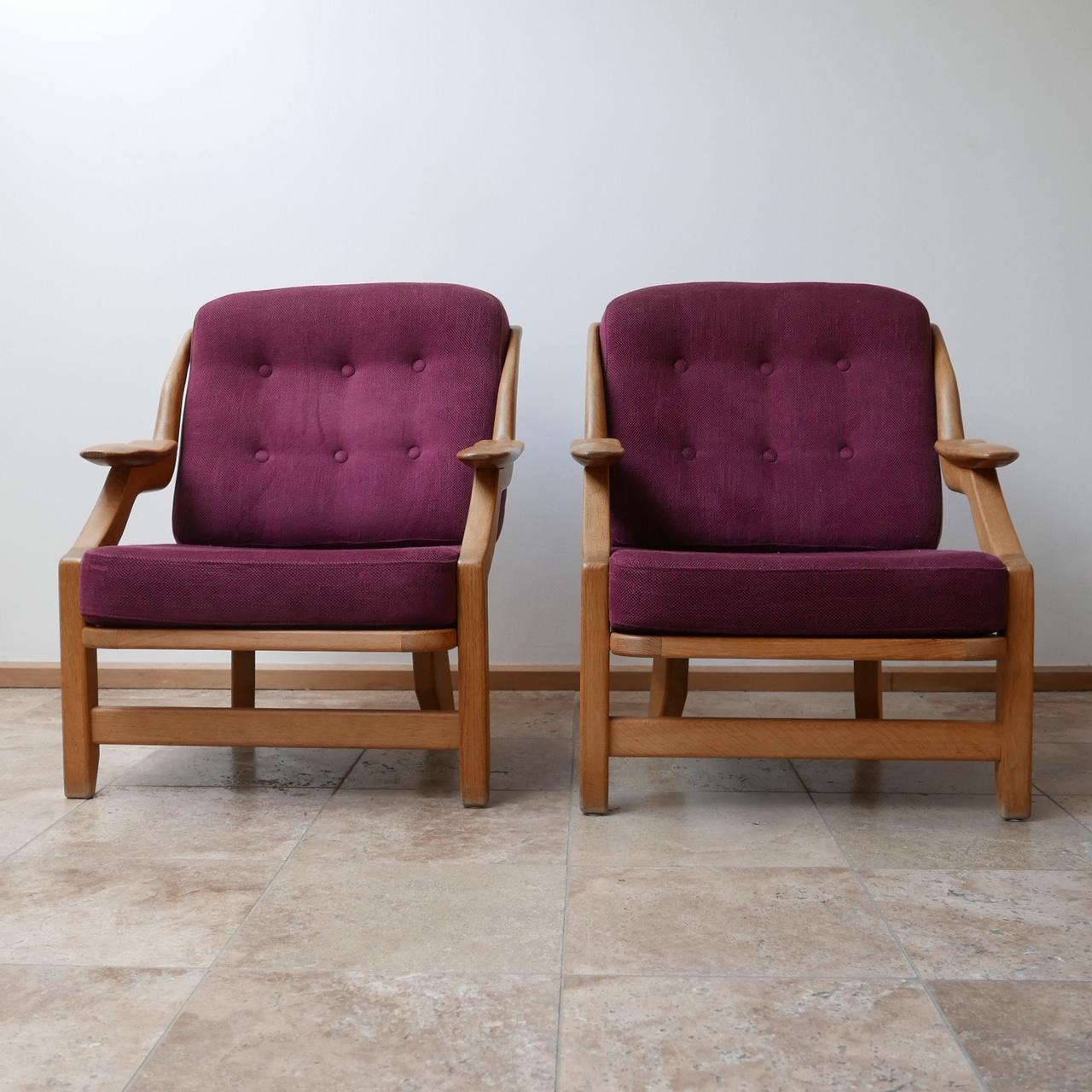 A pair of armchairs by Guillerme et Chambron. 

French, circa 1960s. 

Solid oak and upholstery. 

Original upholstery, which can be updated but is perfectly usable. 

Dimensions: 77 W x 86 D x 41 seat height x 90 total height in cm.