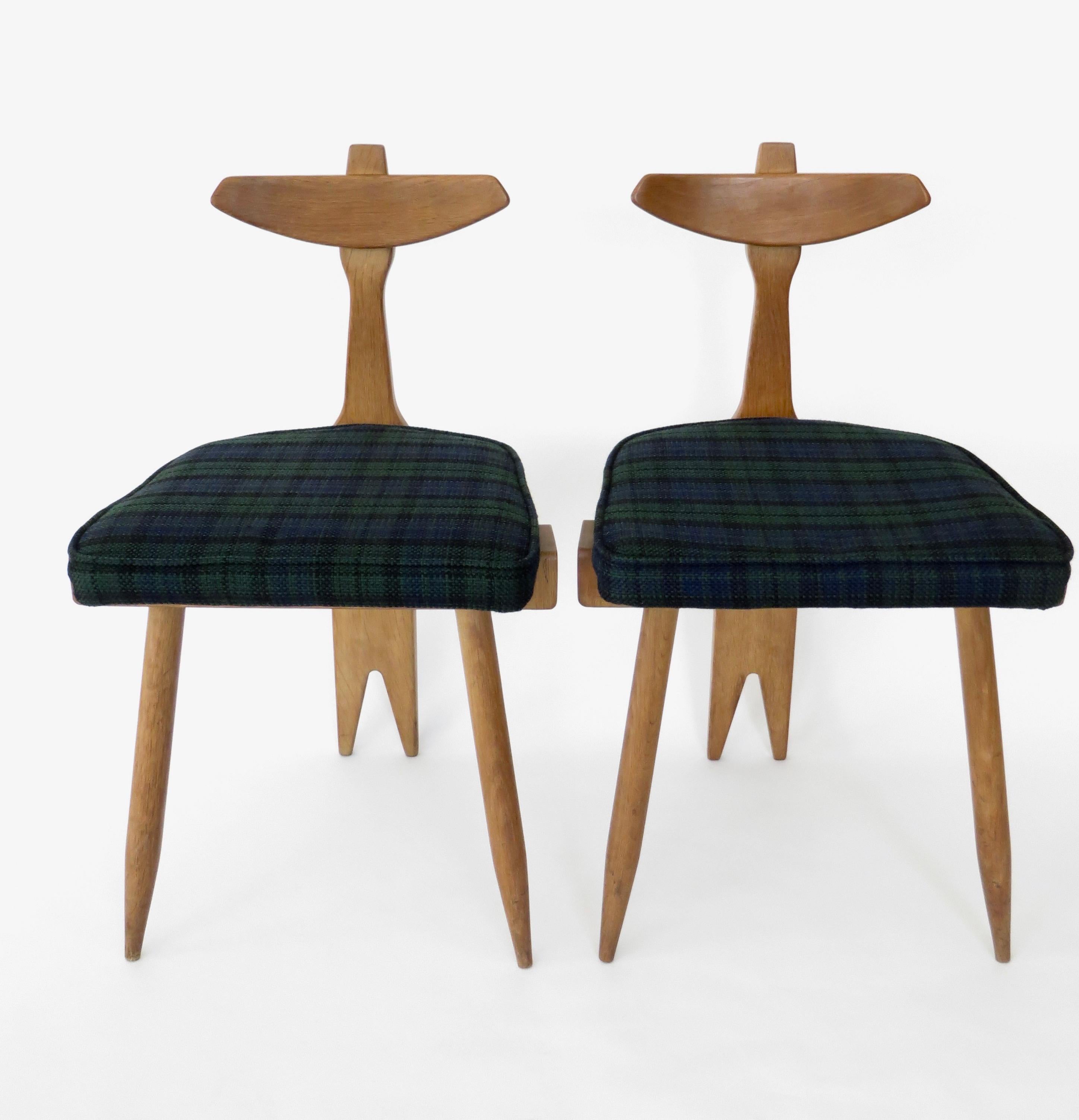A pair of oak and fabric side or vanity tripod sculptural chairs by Guillerme et Chambron.
Influenced by African chairs and thrones.
French oak and original upholstered seat. Ready to use as is or a simple upholstery change.
The oak wood is in