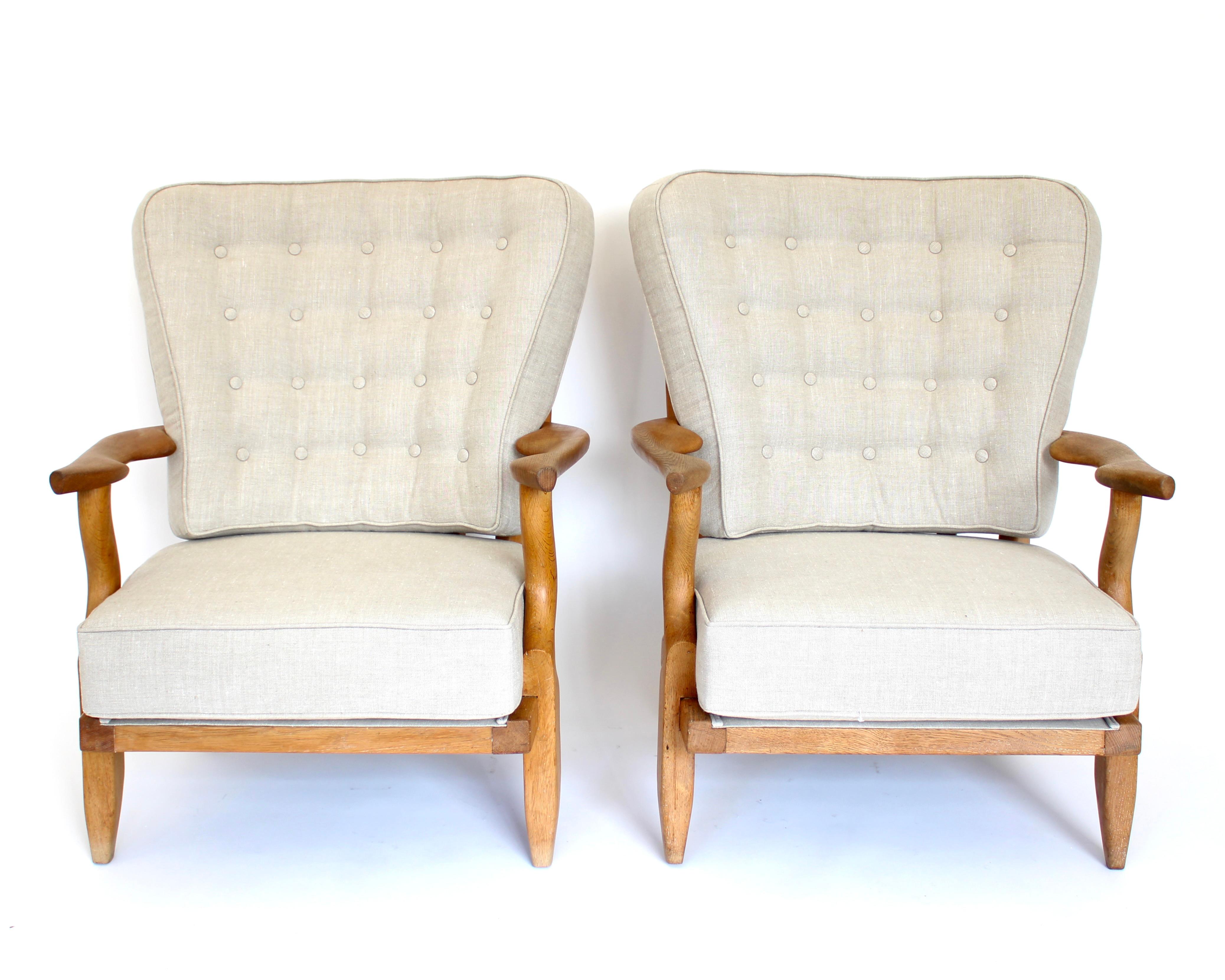 Gullerme et Chambron or Guillerme and Chambron pair of extraordinary French vintage circa 1950 Petite Repos high back lounge chairs in solid oak with the typical characteristic finger motif at the backs for Votre Maison. 
This highly sculptural