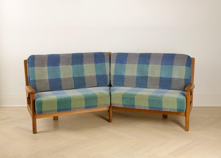 This midcentury curved sofa by the celebrated French designer Robert Guillerme, was created as part of a line of design he produced for the company Votre Maison. In polished oak and upholstery.

Guillerme placed equal emphasis on function and