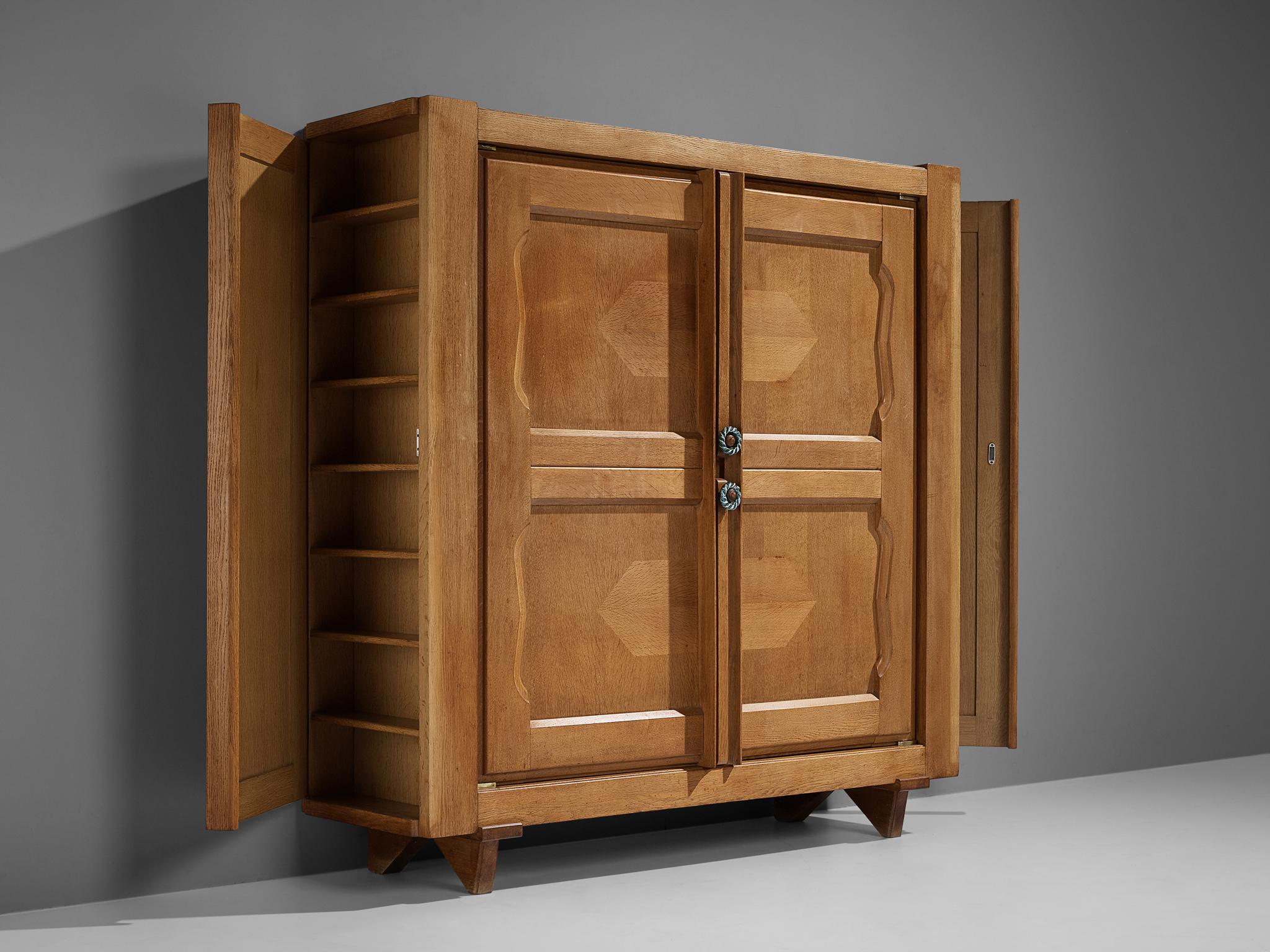 Guillerme et Chambron for Votre Maison, 'Raphael' cabinet, oak, brass, ceramics, France, 1960s

This cabinet is designed by Guillerme et Chambron and features geometric inlays in the doors. The cabinet offers plenty of storage with four shelves. On