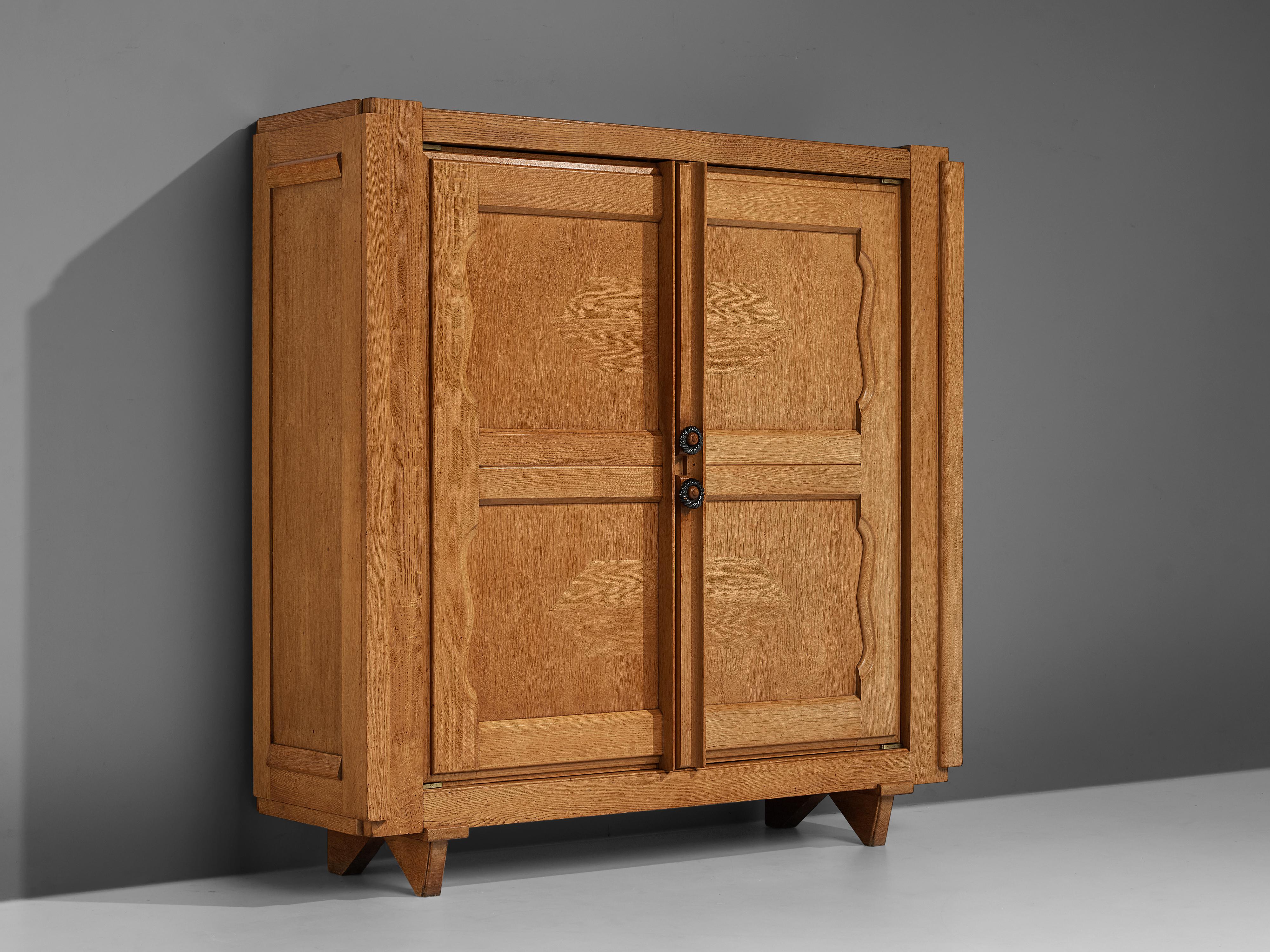 Guillerme et Chambron for Votre Maison, 'Raphael' cabinet, oak, brass, ceramics, France, 1960s

This cabinet is designed by Guillerme et Chambron and features geometric inlays in the doors. The cabinet offers plenty of storage with four shelves.